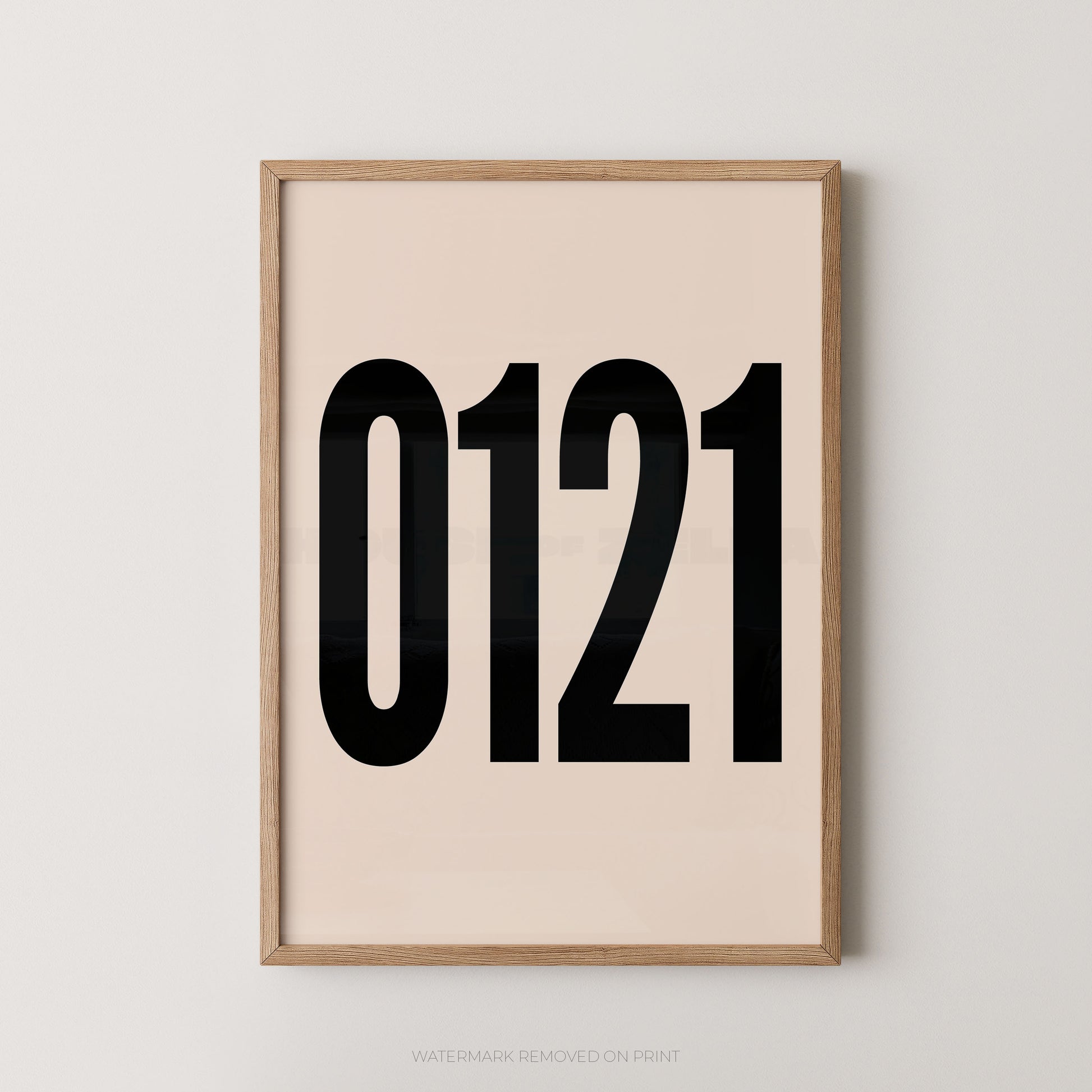 A framed minimalist art print featuring '0121' in black on a cream background, enclosed in a natural wood frame.