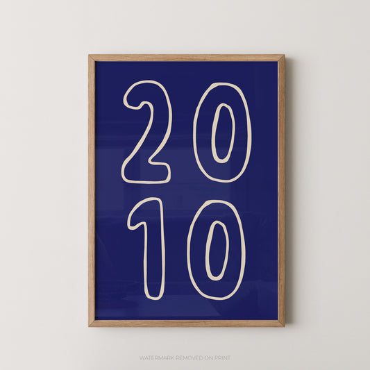 Framed wall art print with large white outlined numbers '2010' on a deep blue background, shown hanging against a light neutral wall.