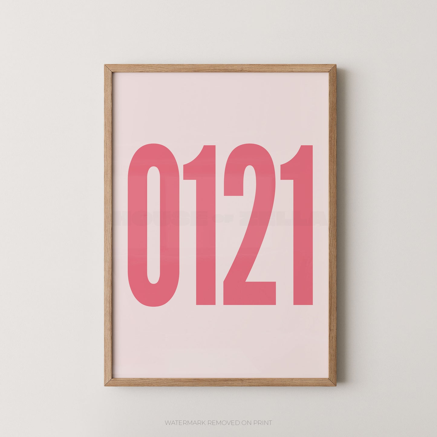 A framed minimalist art print featuring '0121' in pink on a light pink background, enclosed in a natural wood frame.