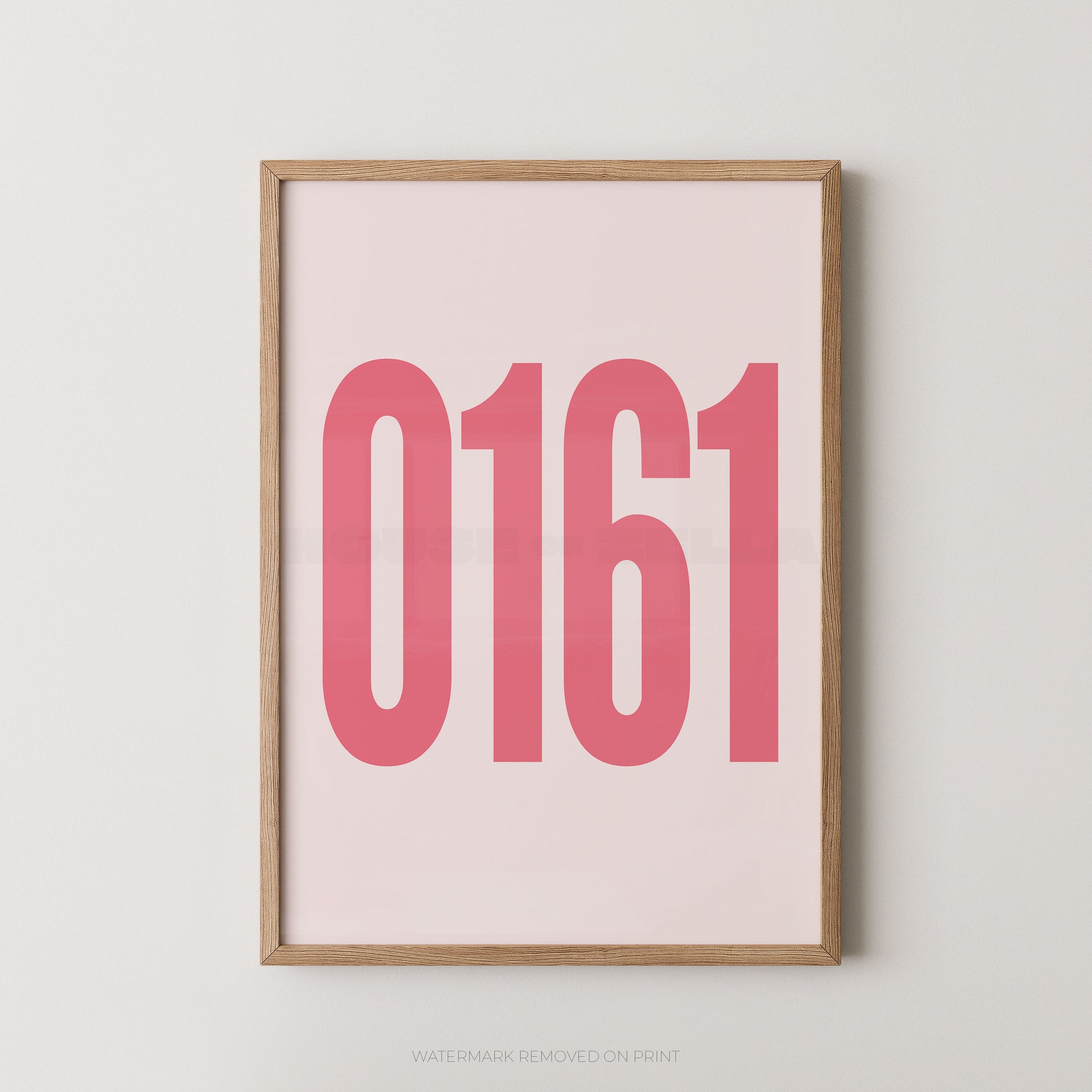A framed minimalist art print featuring the numbers '0161' in a bold pink font on a pale pink background, enclosed in a light natural wood frame against a neutral light gray wall.