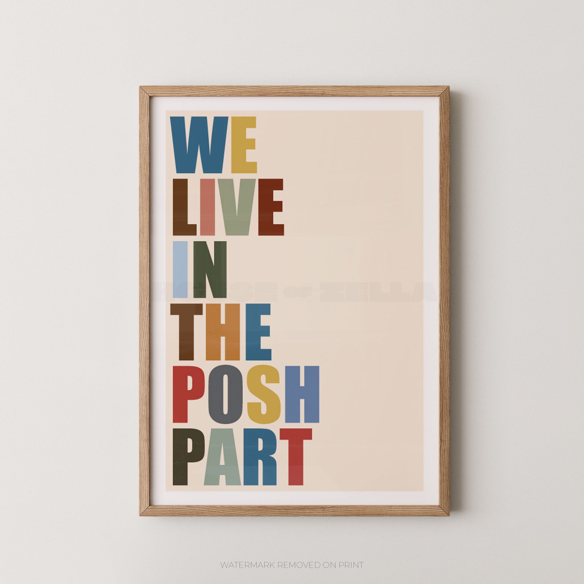 "We Live In The Posh Part multicolour typography wall art print with bold block letters in blue, red, green, yellow and brown on a cream background, displayed straight-on in an oak frame"

