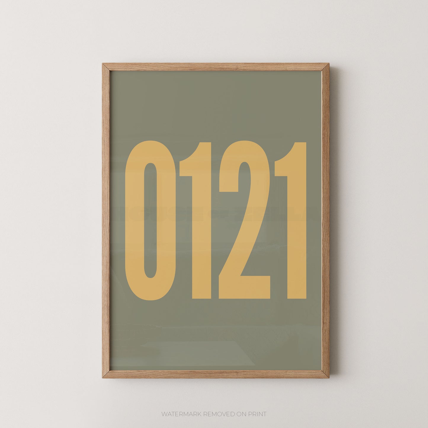 A framed minimalist art print featuring '0121' in gold on a greenbackground, enclosed in a natural wood frame.