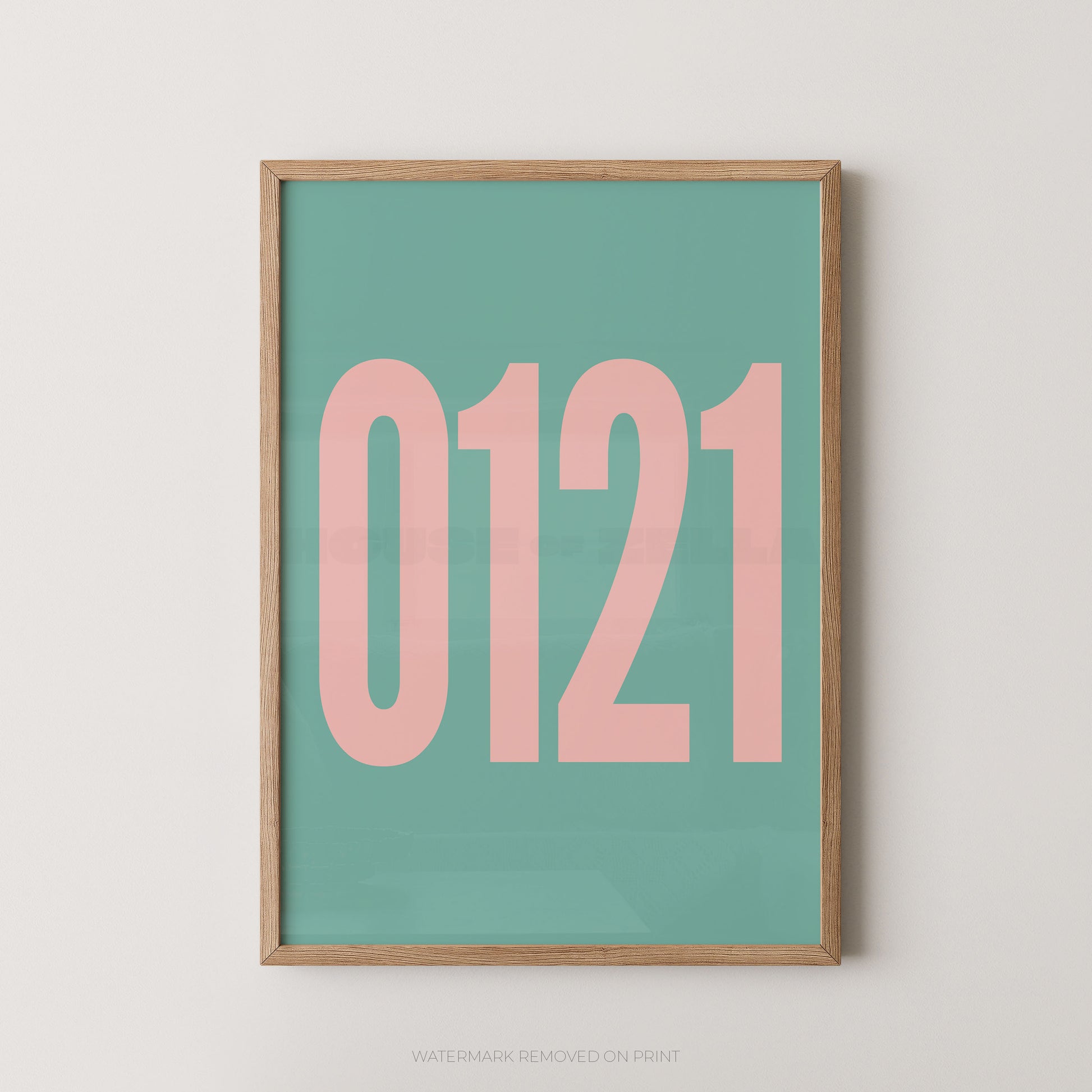 A framed minimalist art print featuring '0121' in pink on a blue background, enclosed in a natural wood frame.