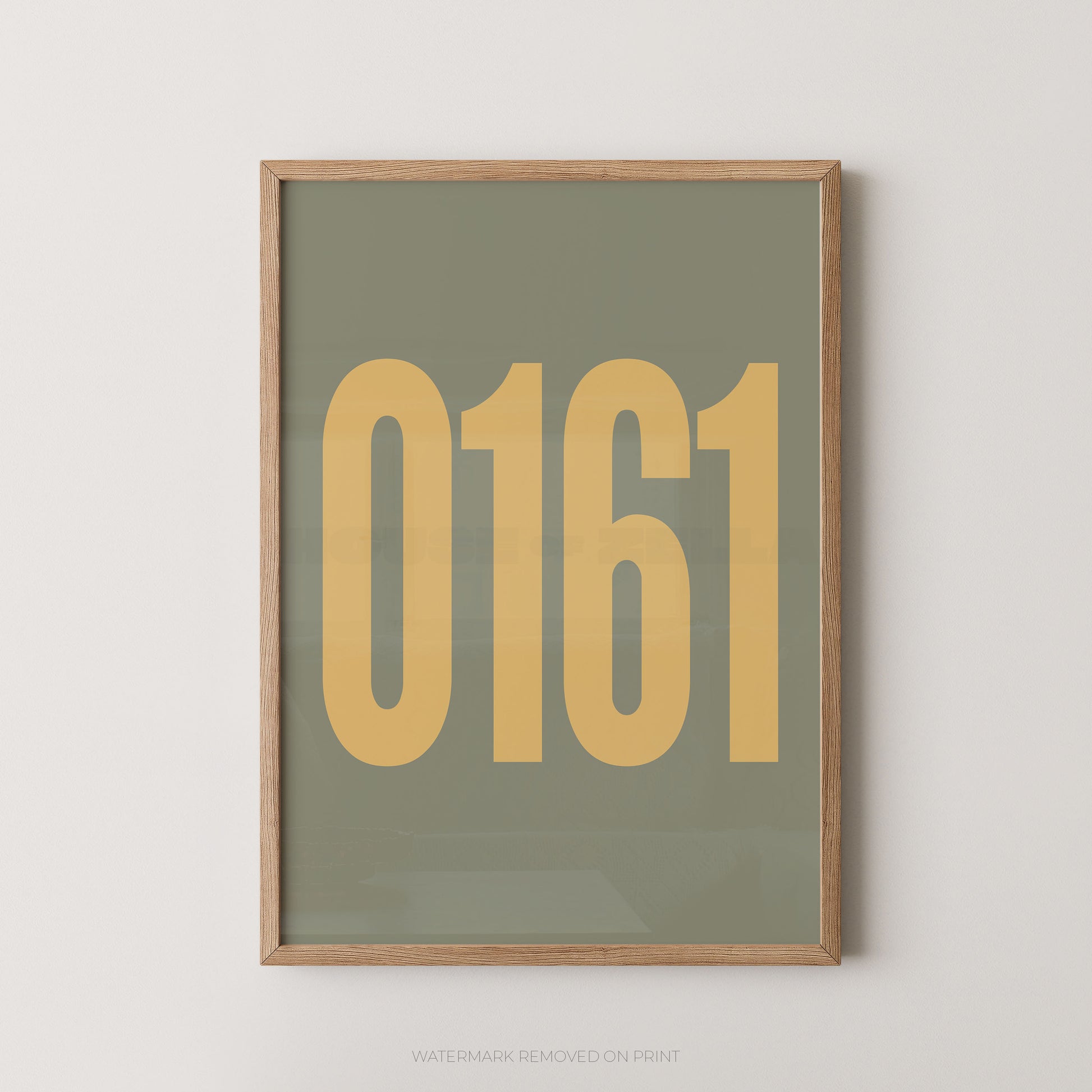A framed minimalist art print featuring the numbers '0161' in a muted mustard yellow on a sage green background, enclosed in a light natural wood frame.