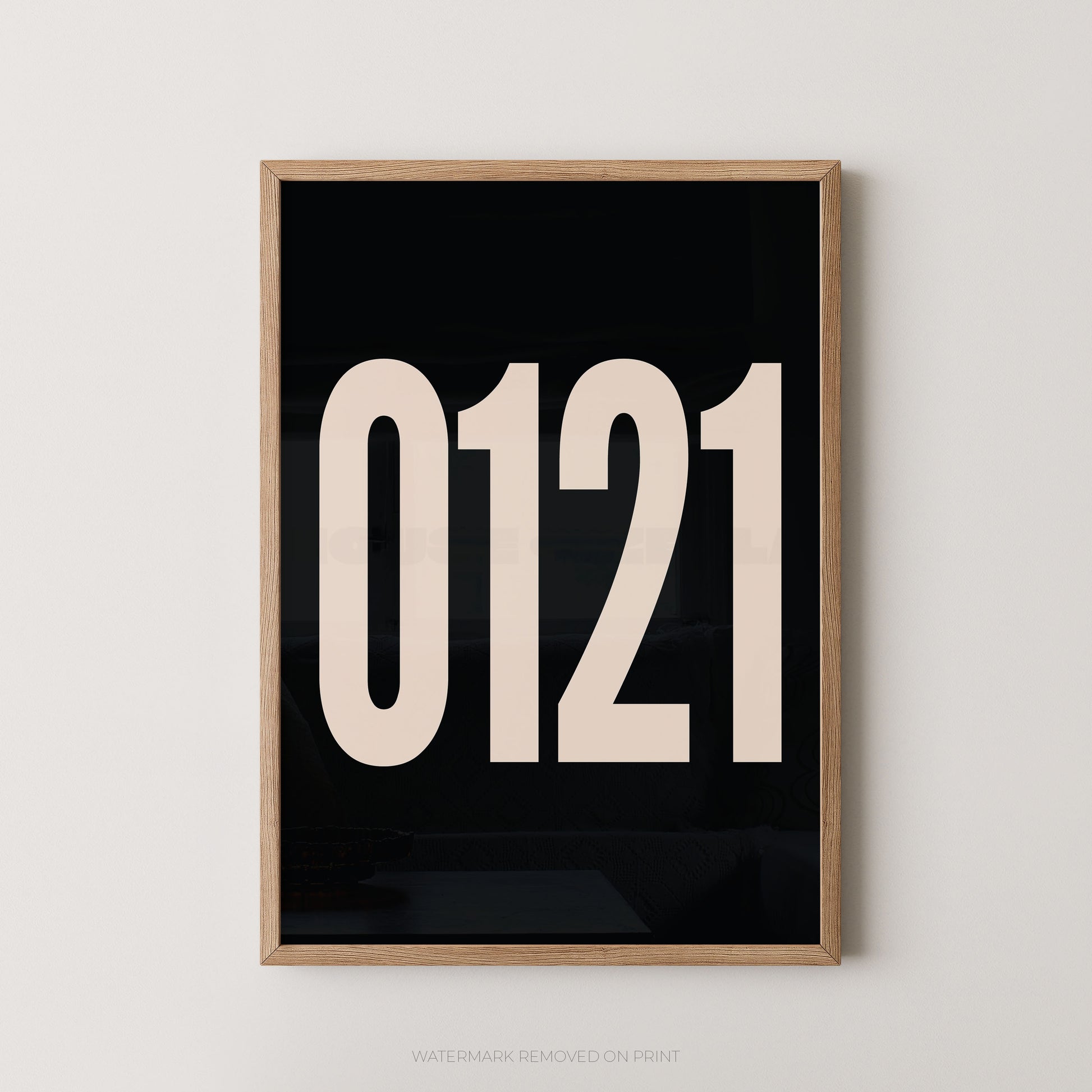 A framed minimalist art print featuring '0121' in white on a black background, enclosed in a natural wood frame.