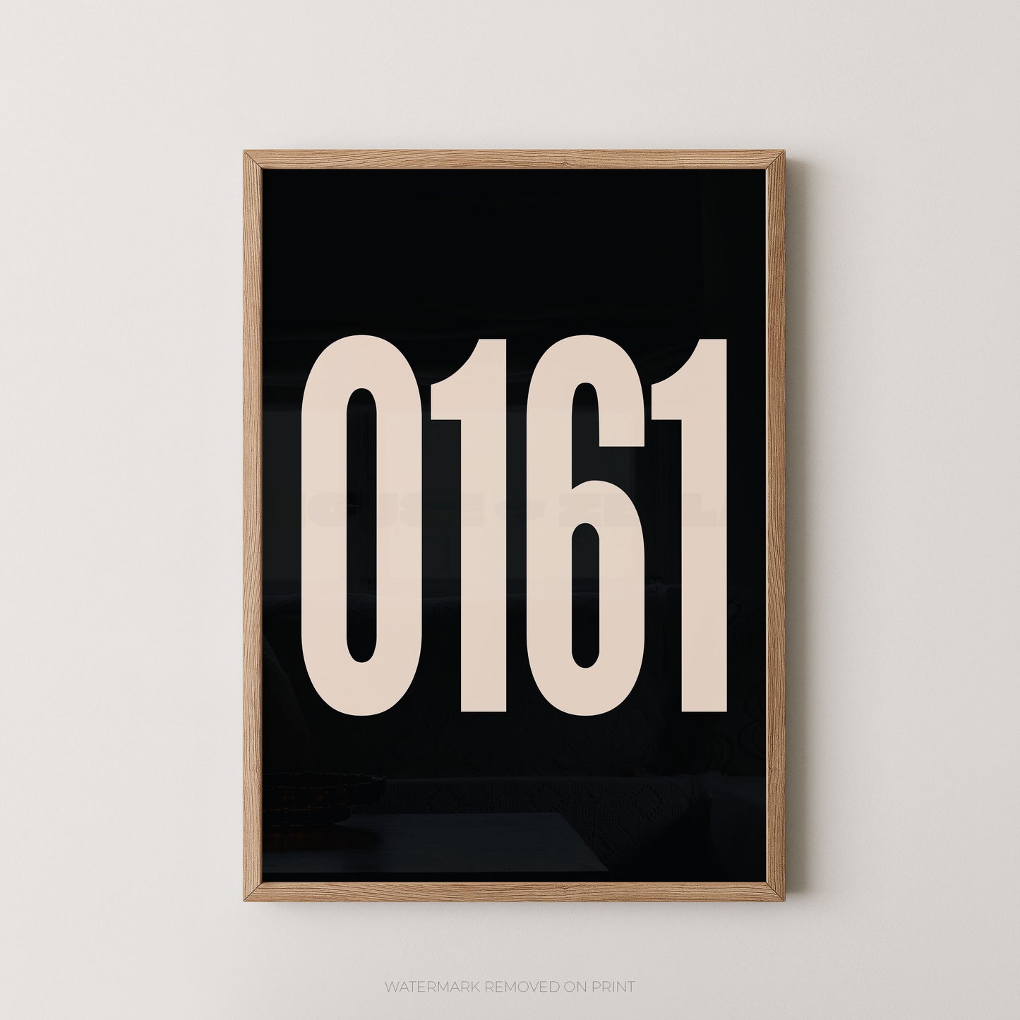 Framed minimalist wall art featuring the large cream-colored numbers '0161' on a solid black background, enclosed in a light natural wood frame and mounted on a neutral light gray wall.