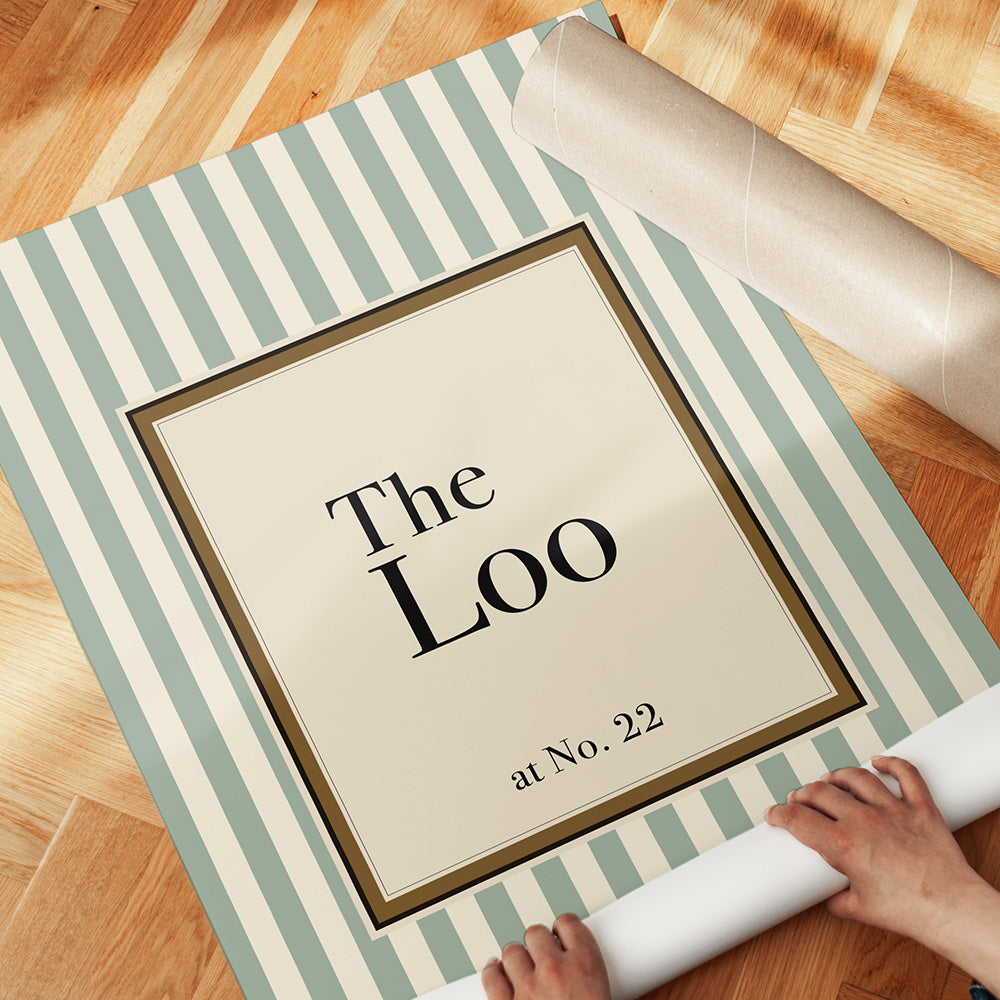 Framed picture with 'The Loo at No. 22' text on a striped background