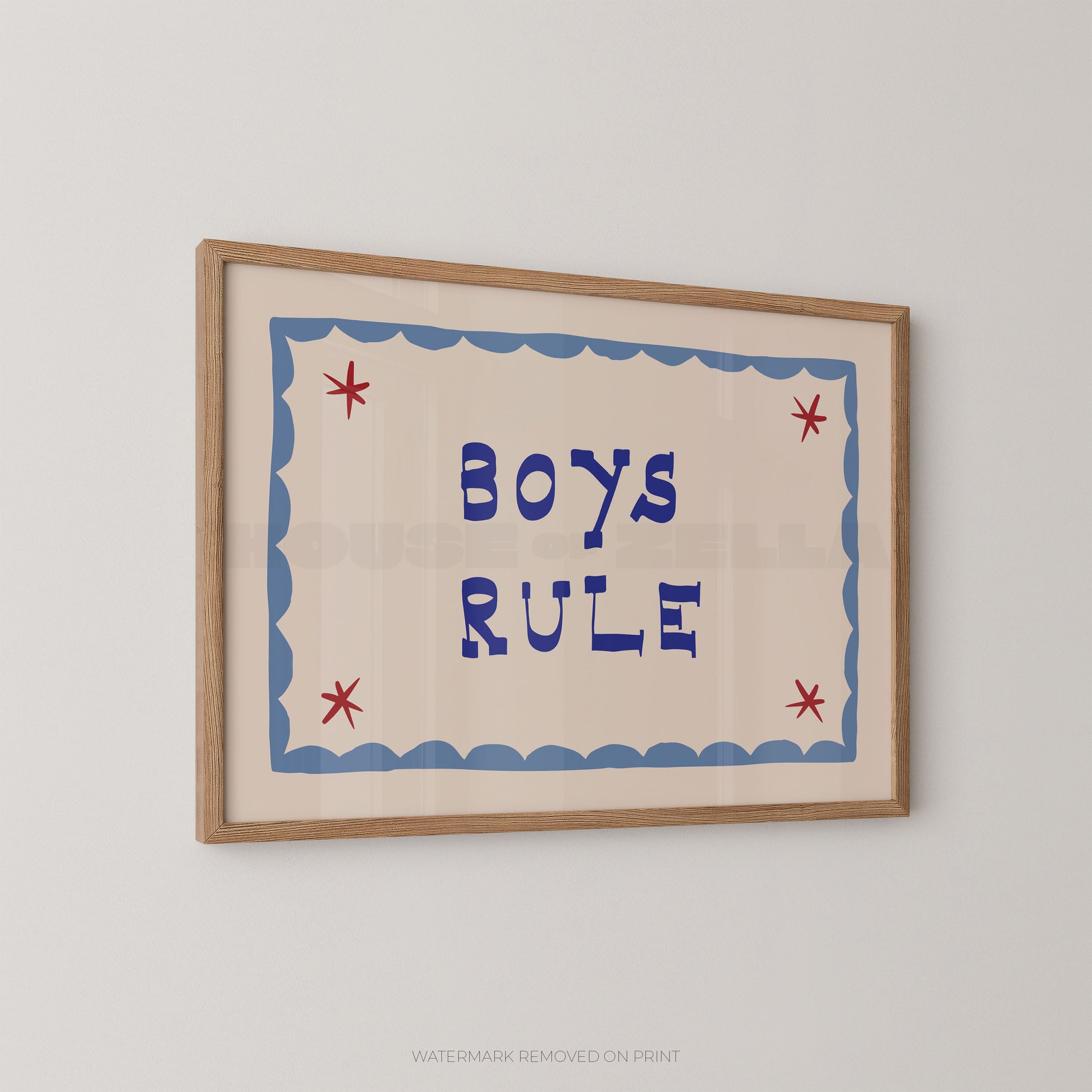 "Boys Rule children's wall art print with bold dark blue retro lettering on a cream background, light blue scallop border with red star details, displayed at an angle in an oak frame"

