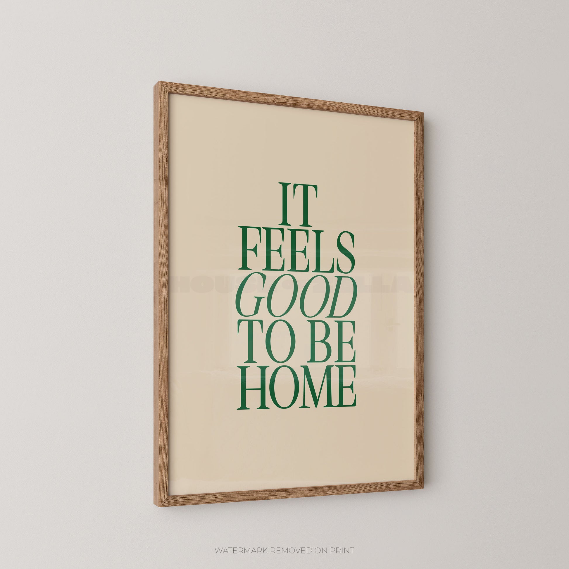 Framed print with 'It Feels Good to Be Home' text on a beige background