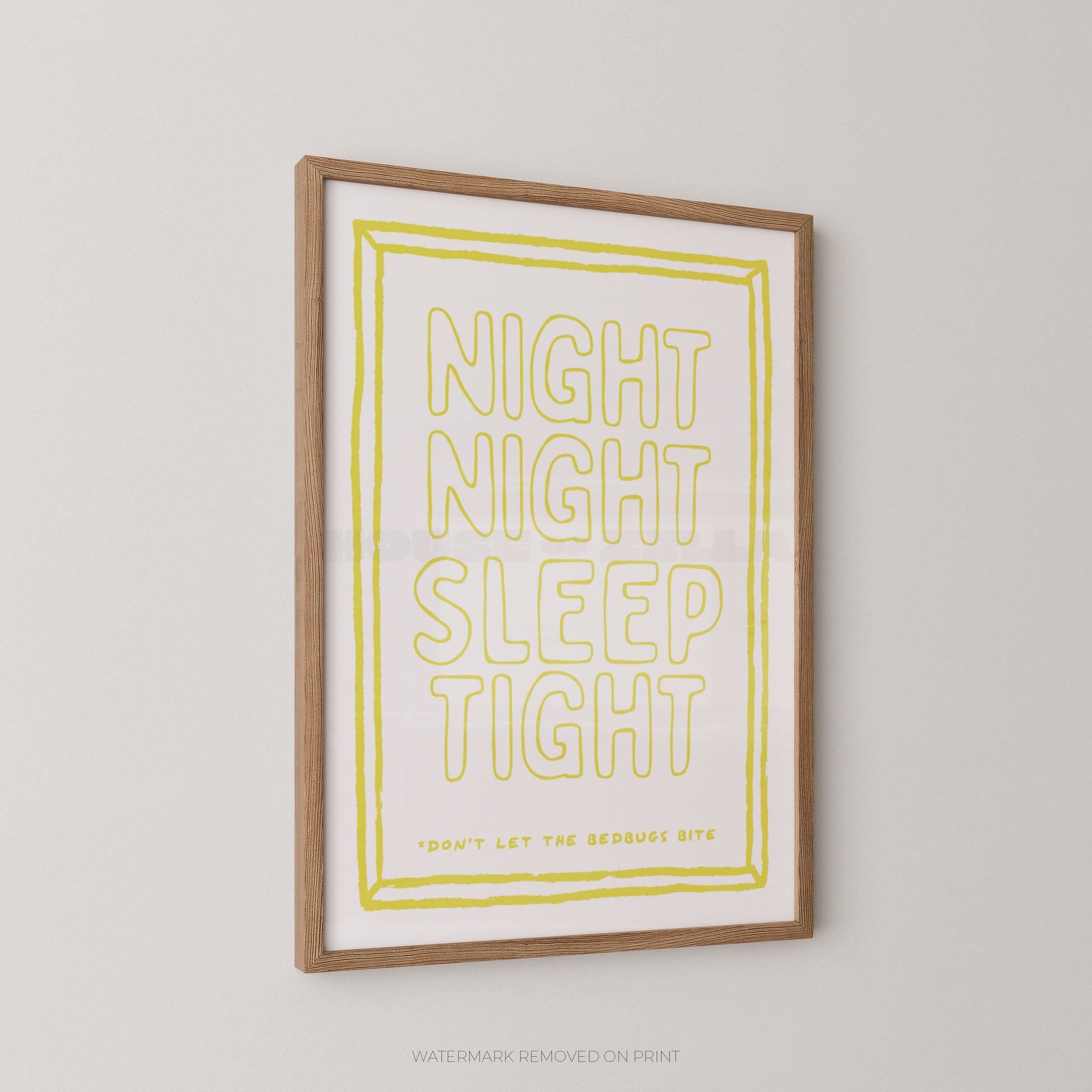 Framed wall art print with the phrase “NIGHT NIGHT SLEEP TIGHT” in large outlined yellow letters on a white background, with a light wood frame, shown hanging on a light gray wall.