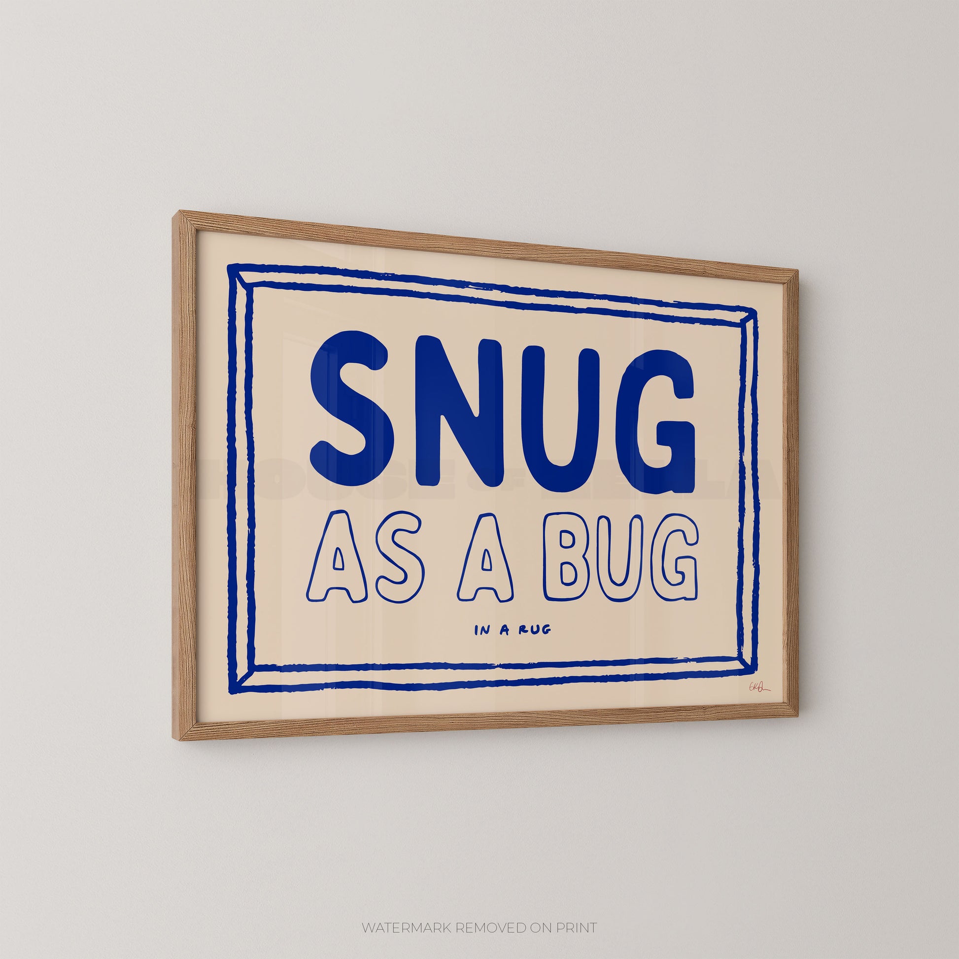 Framed print with 'SNUG AS A BUG' text on a beige background