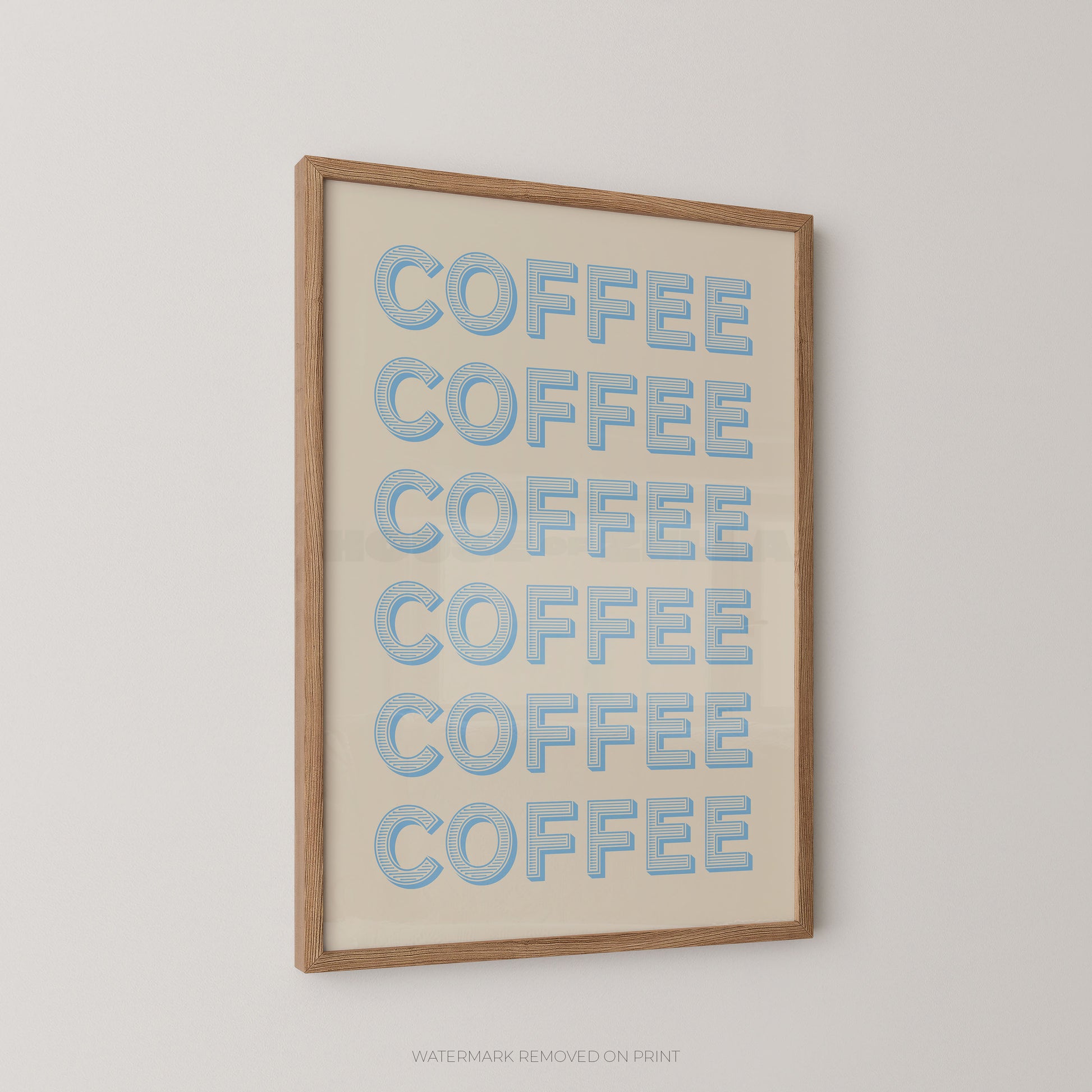 Framed wall art featuring the word 'COFFEE' repeated six times in light blue bubble letters on an off-white background, enclosed in a natural wood frame and shown hanging on a light gray wall.