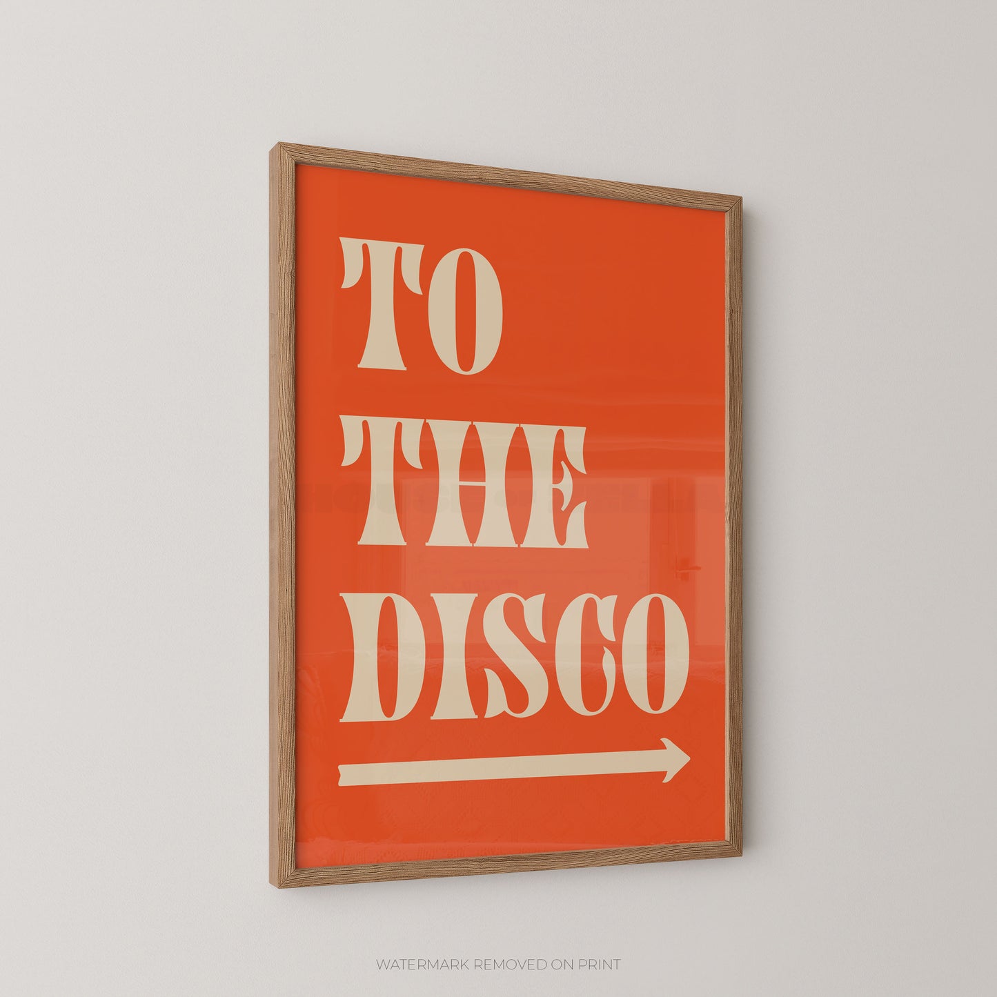 "To The Disco bold retro typography wall art print with cream lettering and a right-pointing arrow on a bold orange background, displayed at an angle in an oak frame"



