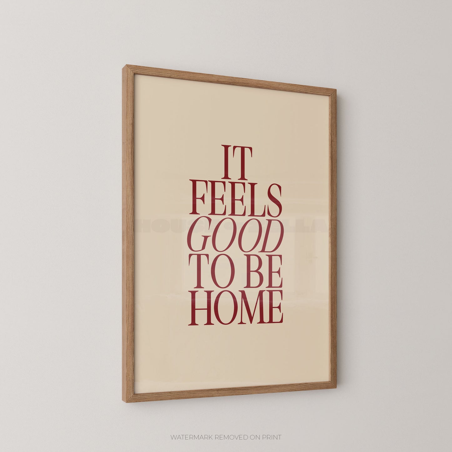 Framed print with 'It Feels Good to Be Home' text on a beige background