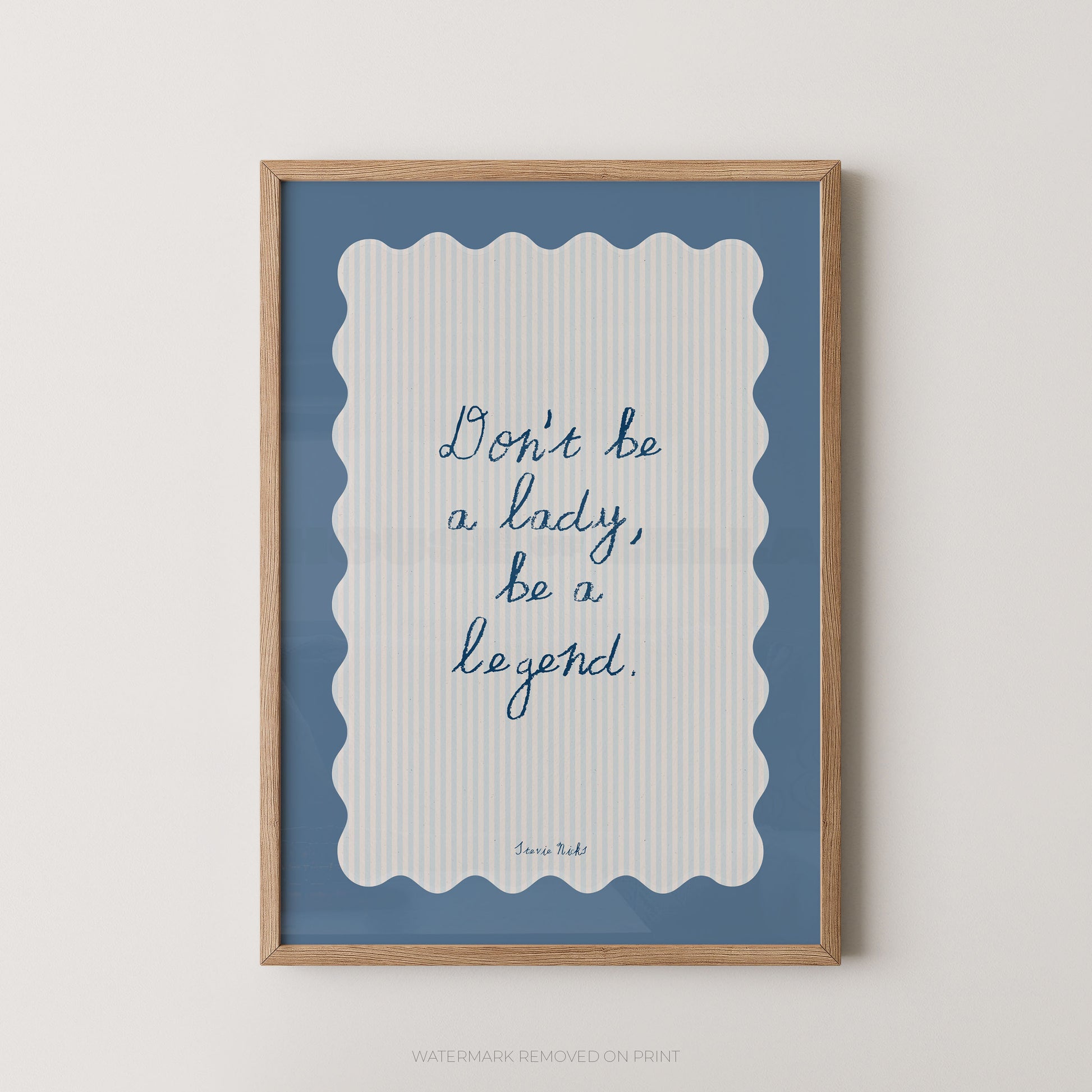 Framed print with motivational quote 'Don't be a lady, be a legend' on a blue and white striped background.