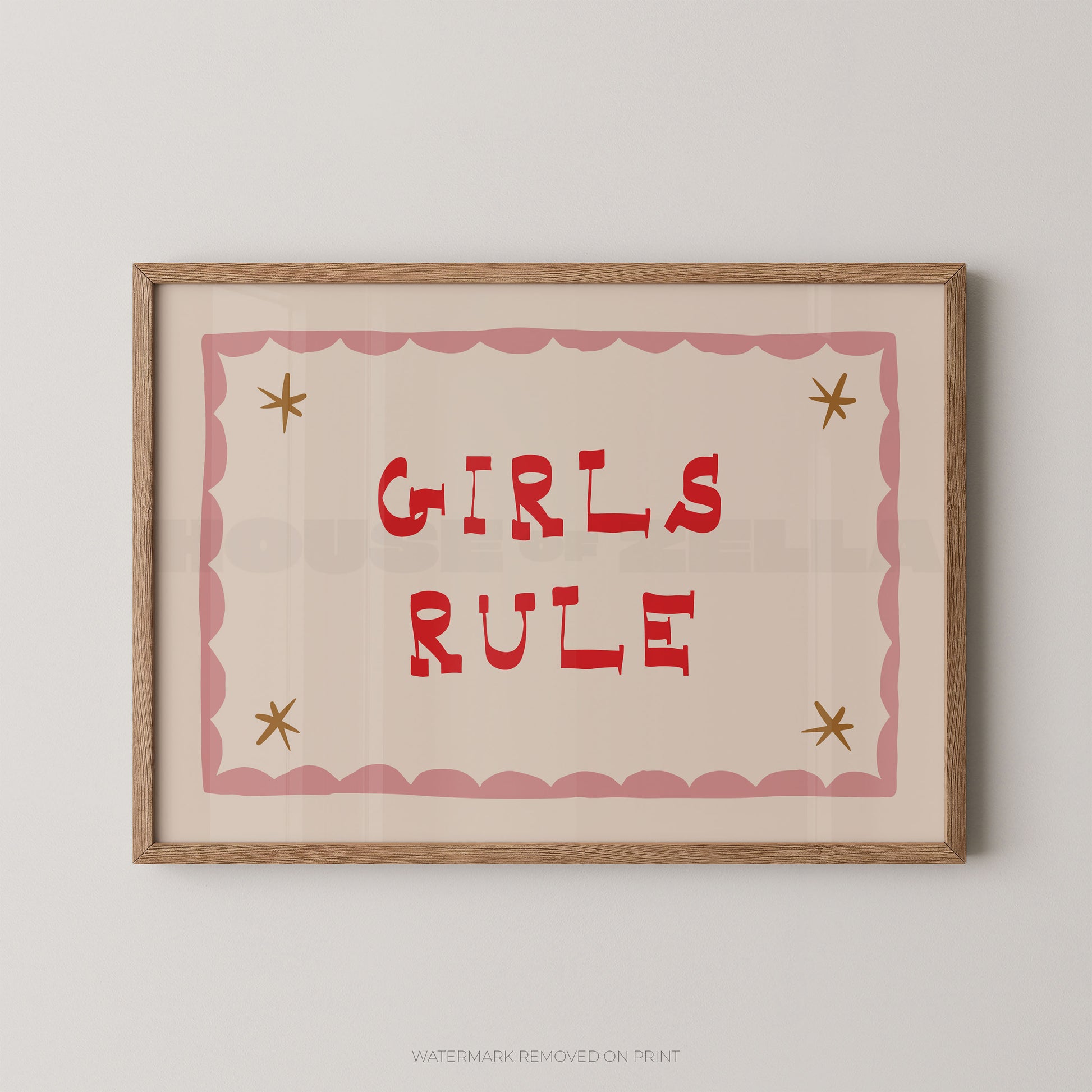 "Girls Rule children's wall art print with bold red retro lettering on a cream background, pink scallop border with gold star details, displayed straight-on in an oak frame"

