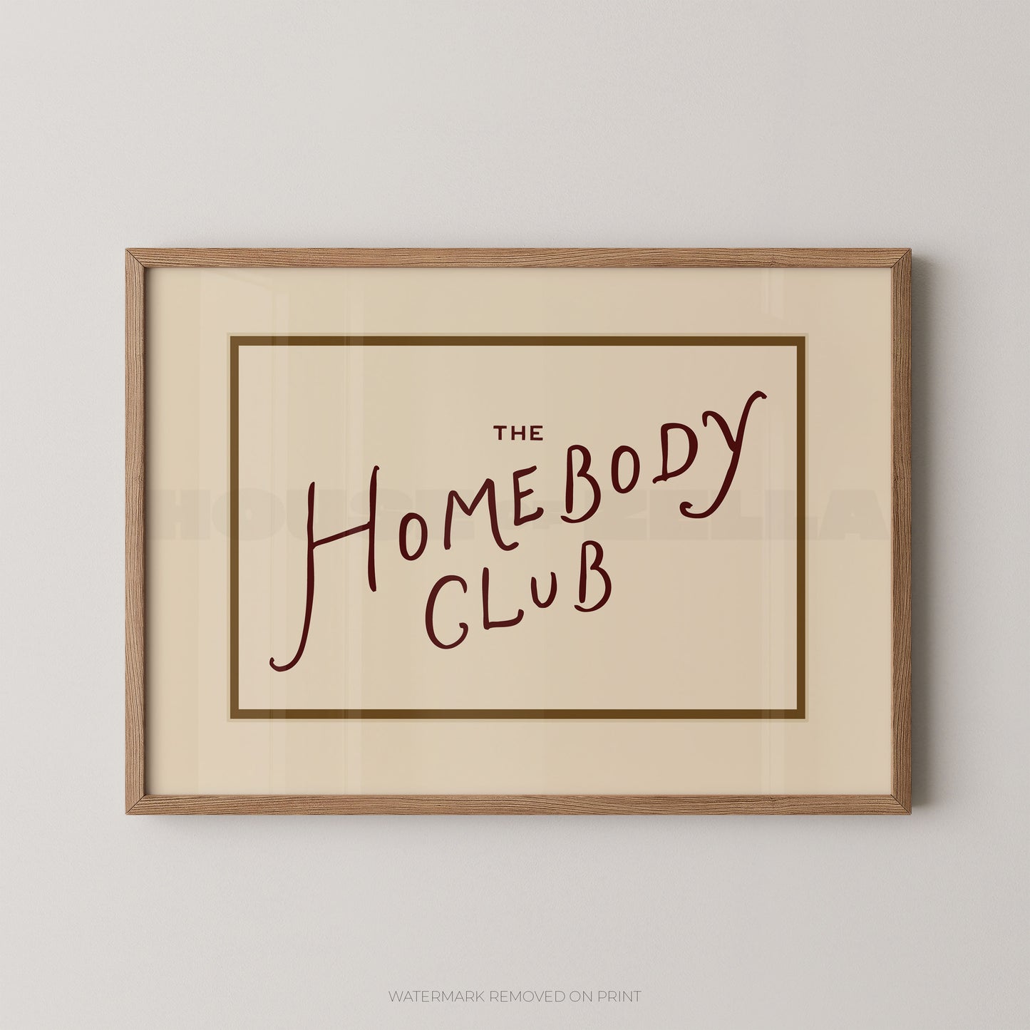 Framed print with 'The Homebody Club' text on a plain background