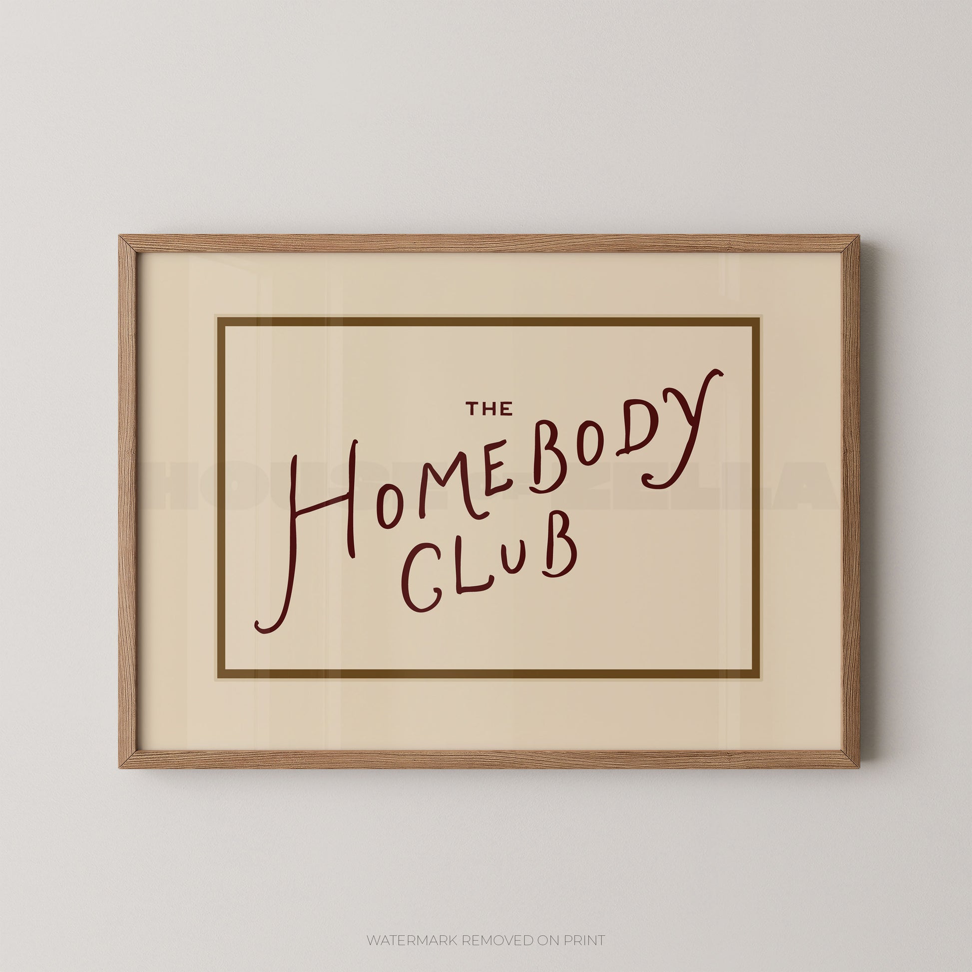 Framed print with 'The Homebody Club' text on a plain background