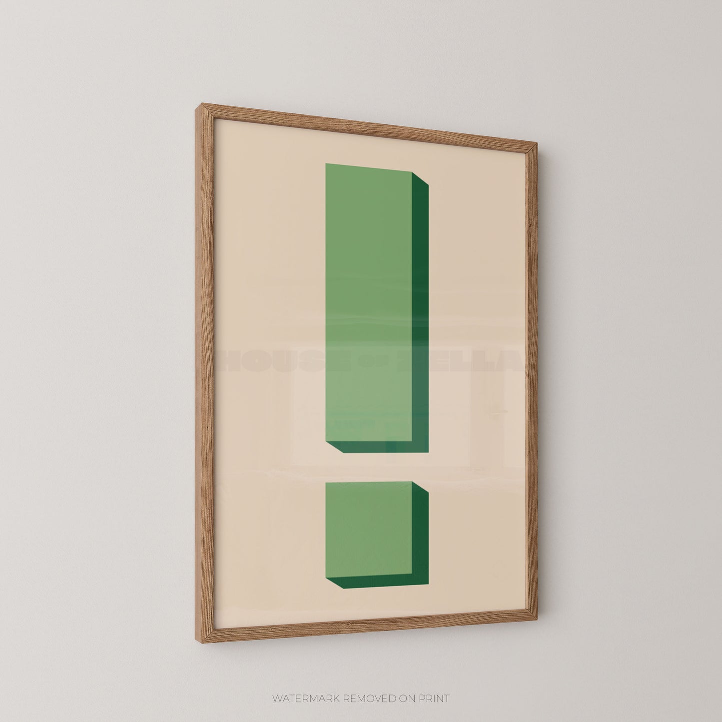 Framed minimalist wall art featuring a green exclamation mark on a warm cream background, hung on a light gray wall.