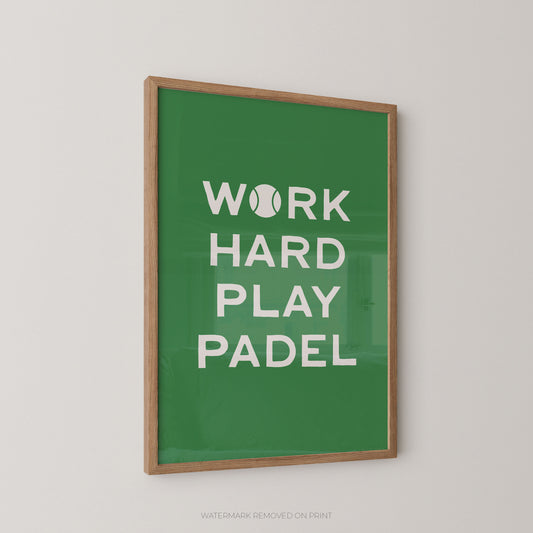 A framed wall art print with a green background and white text reading “WORK HARD PLAY PADEL,” with a tennis ball icon replacing the letter O in “WORK.” The print is shown hanging on a light gray wall.