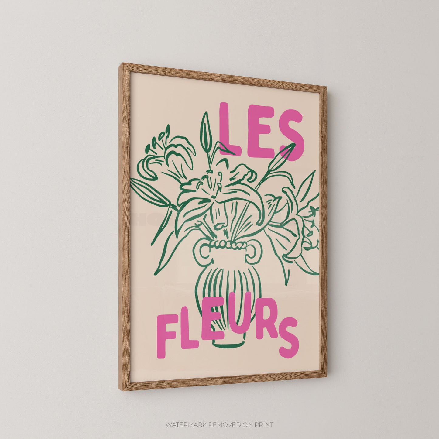 A framed art print featuring a green line drawing of a flower bouquet with the French text 'LES FLEURS' in pink on a cream background, enclosed in a light wood frame.