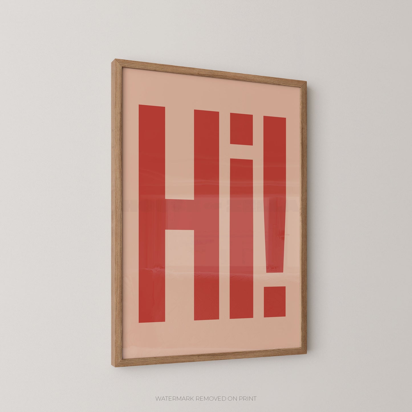 Framed typographic wall art featuring the word 'Hi!' in bold red letters on a warm peach background, enclosed in a light natural wood frame and shown hanging on a light gray wall.