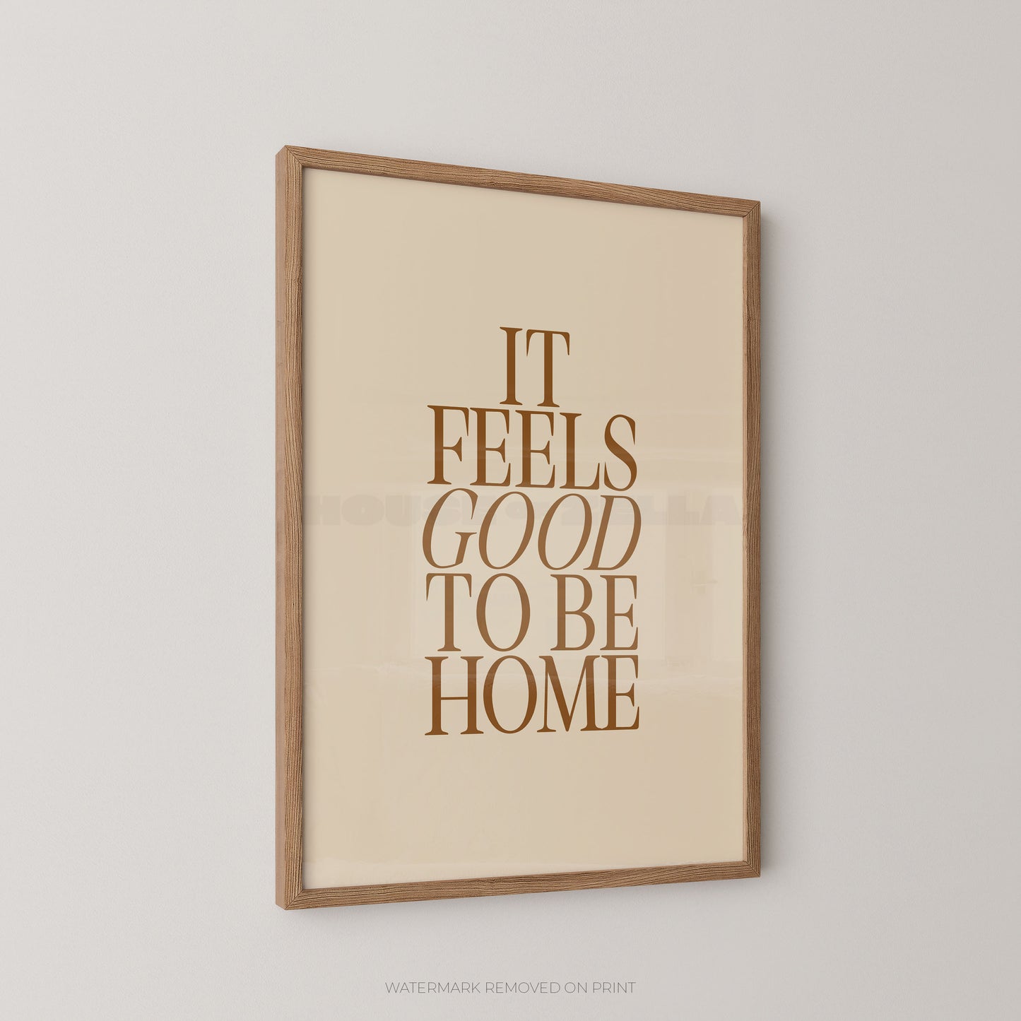Framed print with 'It Feels Good to Be Home' text on a beige background