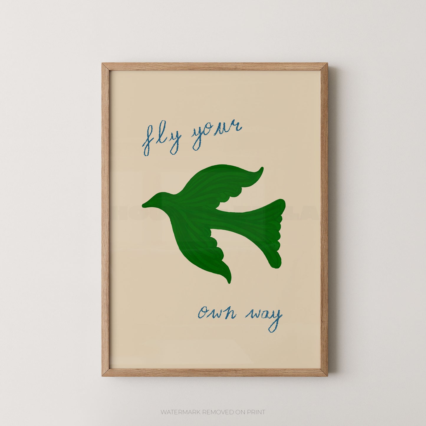Fly your own way inspirational wall art print featuring a green bird silhouette in flight with blue handwritten script text on a cream background, displayed in an oak frame