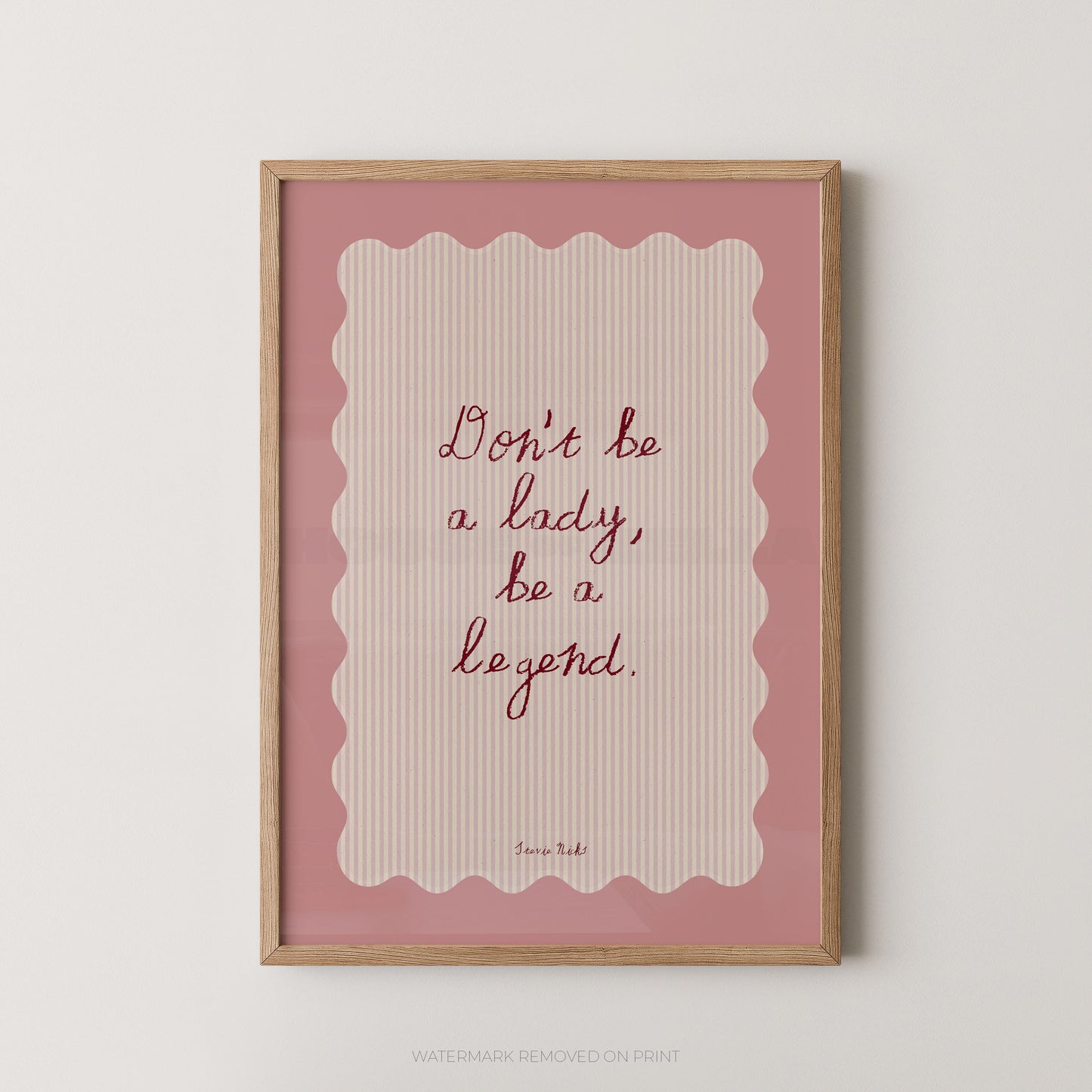 Framed print with motivational quote 'Don't be a lady, be a legend' on a pink background