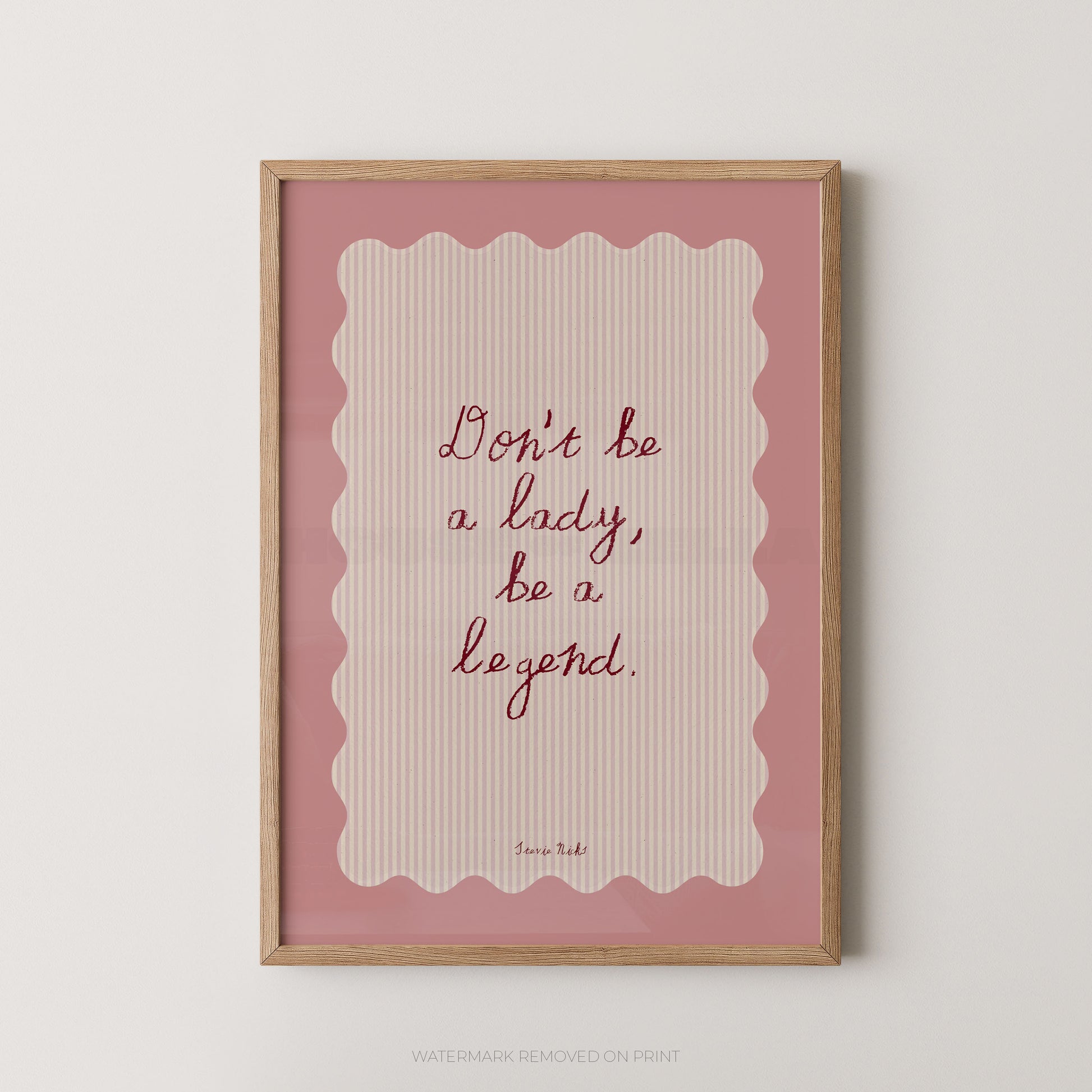 Framed print with motivational quote 'Don't be a lady, be a legend' on a pink background
