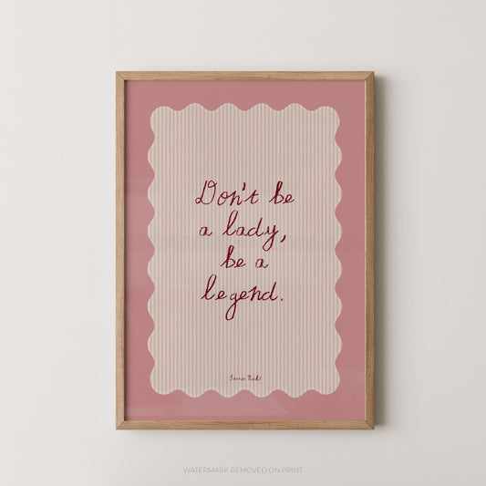 Framed print with motivational quote 'Don't be a lady, be a legend' on a pink background