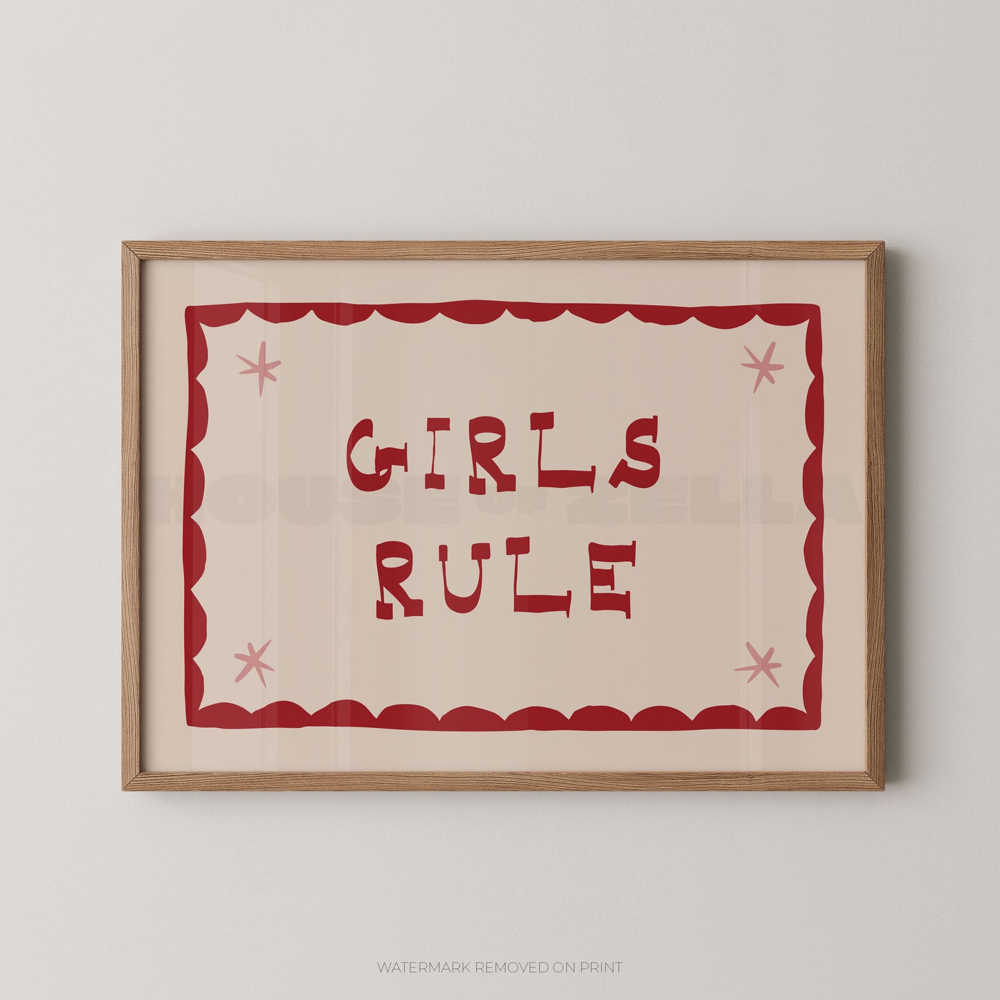 "Girls Rule children's wall art print with bold dark red retro lettering on a cream background, red scallop border with pink star details, displayed straight-on in an oak frame"

