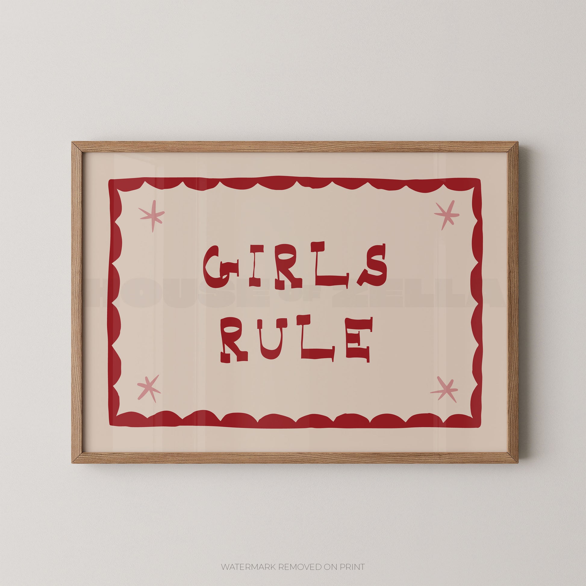 "Girls Rule children's wall art print with bold dark red retro lettering on a cream background, red scallop border with pink star details, displayed straight-on in an oak frame"

