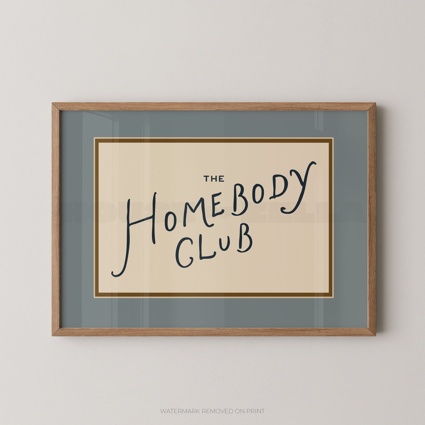 Framed print with 'The Homebody Club' text on a plain background