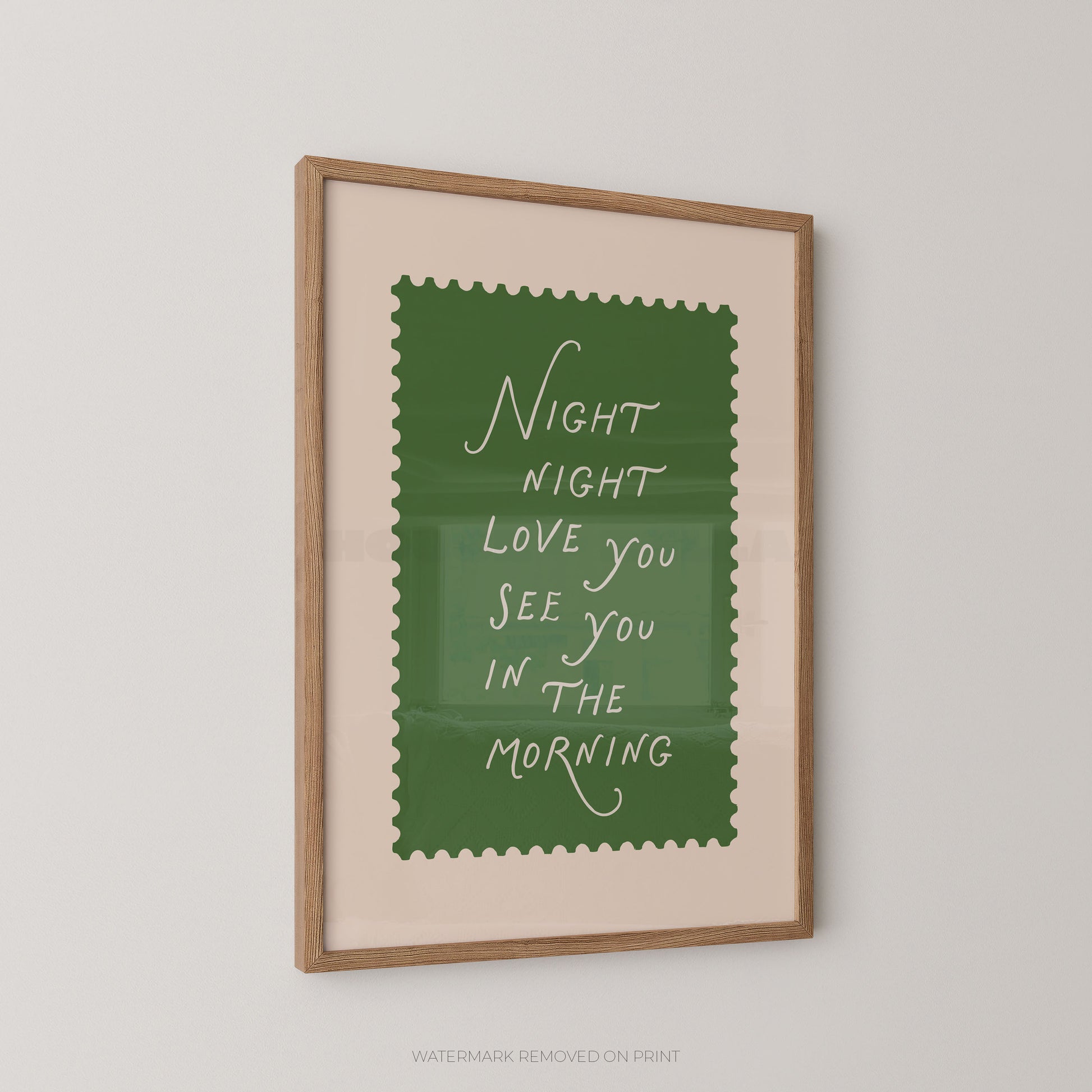 Framed print with a green background and white text on a beige wall.