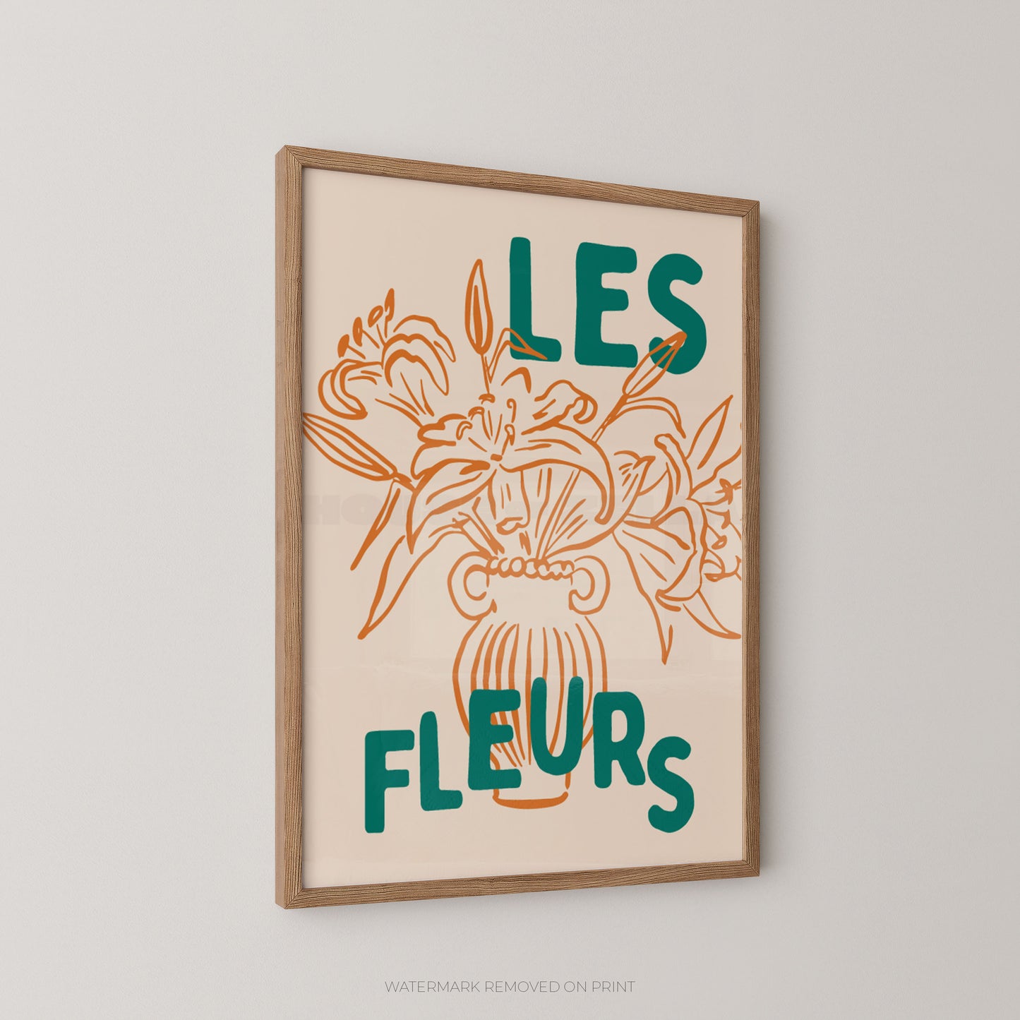 Framed wall art print with the French text “LES FLEURS” in teal over an orange line drawing of flowers in a vase, shown hanging on a light gray wall.
