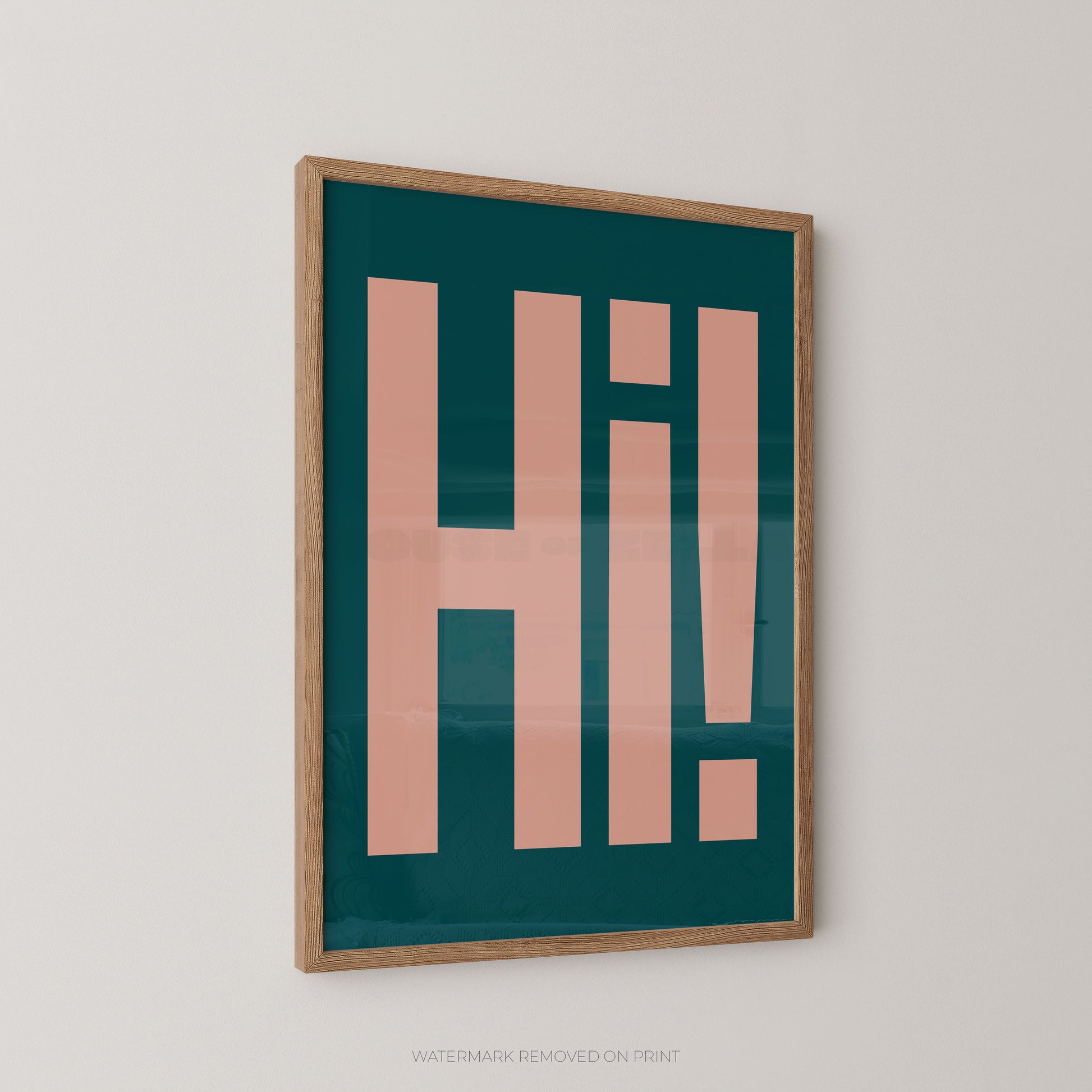 Framed typographic wall art featuring large pink letters spelling 'Hi!' on a dark teal background, shown hanging on a light gray wall.
