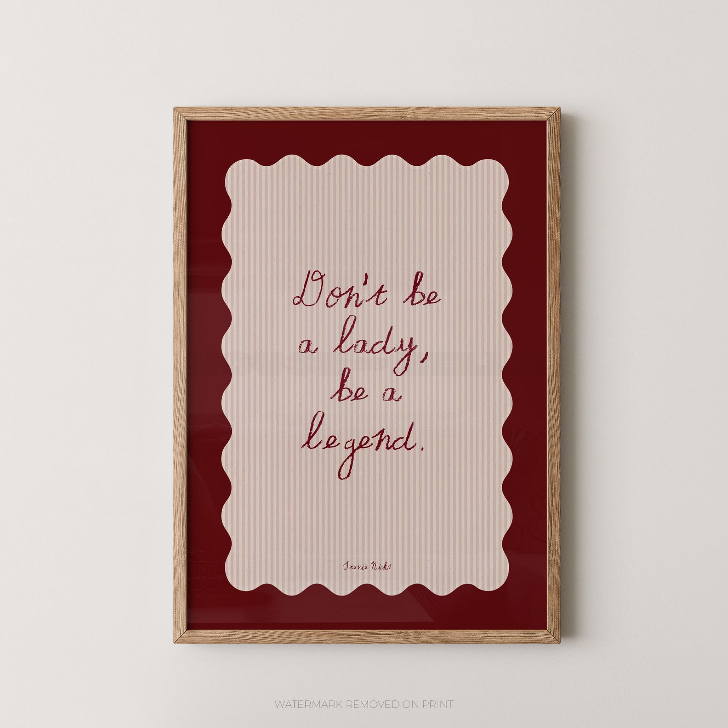 Framed print with text 'Don't be a lady, be a legend' on a red background