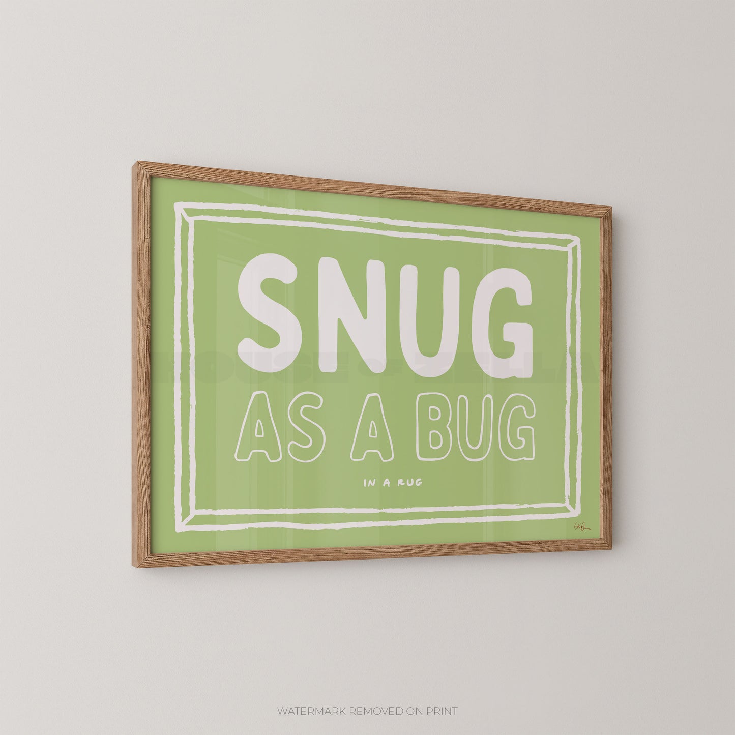 Framed print with 'SNUG AS A BUG' text on a green background