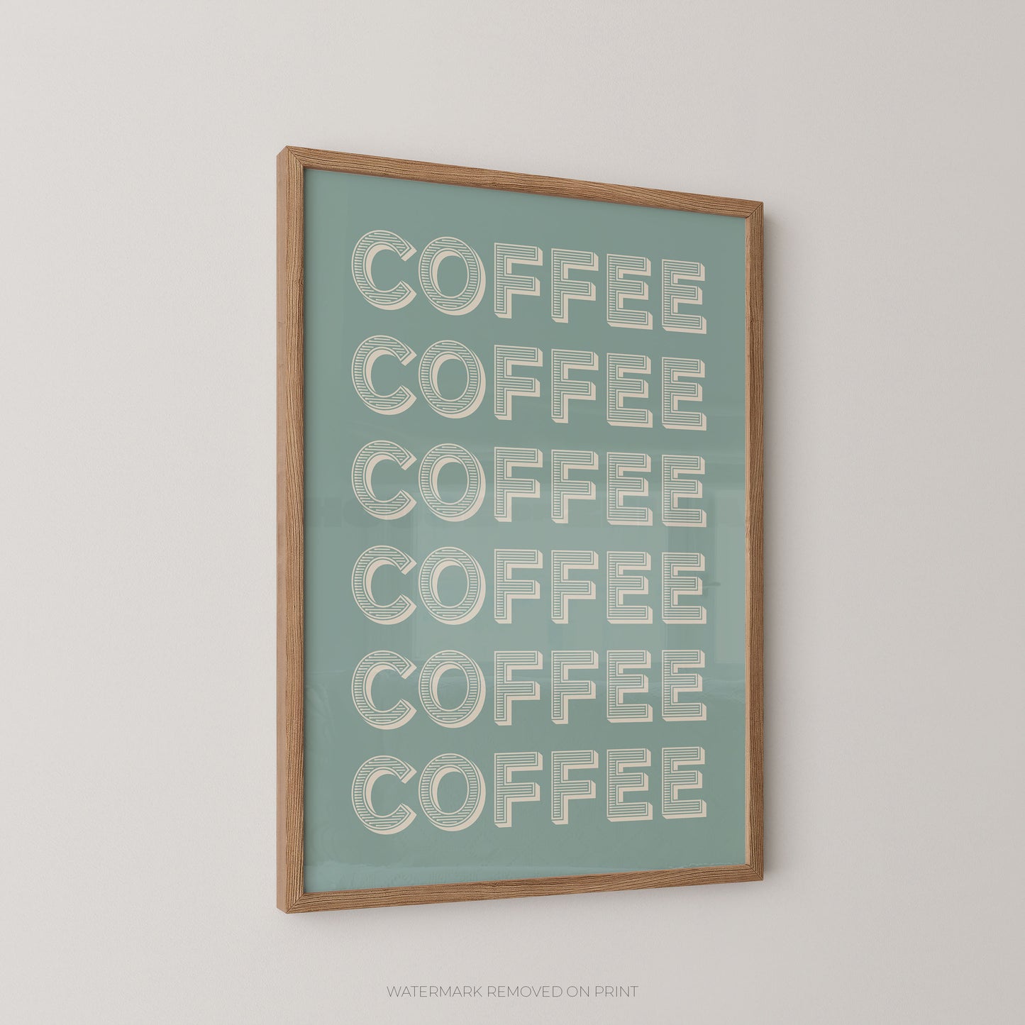 A framed wall art print featuring the word 'COFFEE' repeated six times in large white letters on a muted teal background, enclosed in a light natural wood frame and shown hanging on a plain light wall.