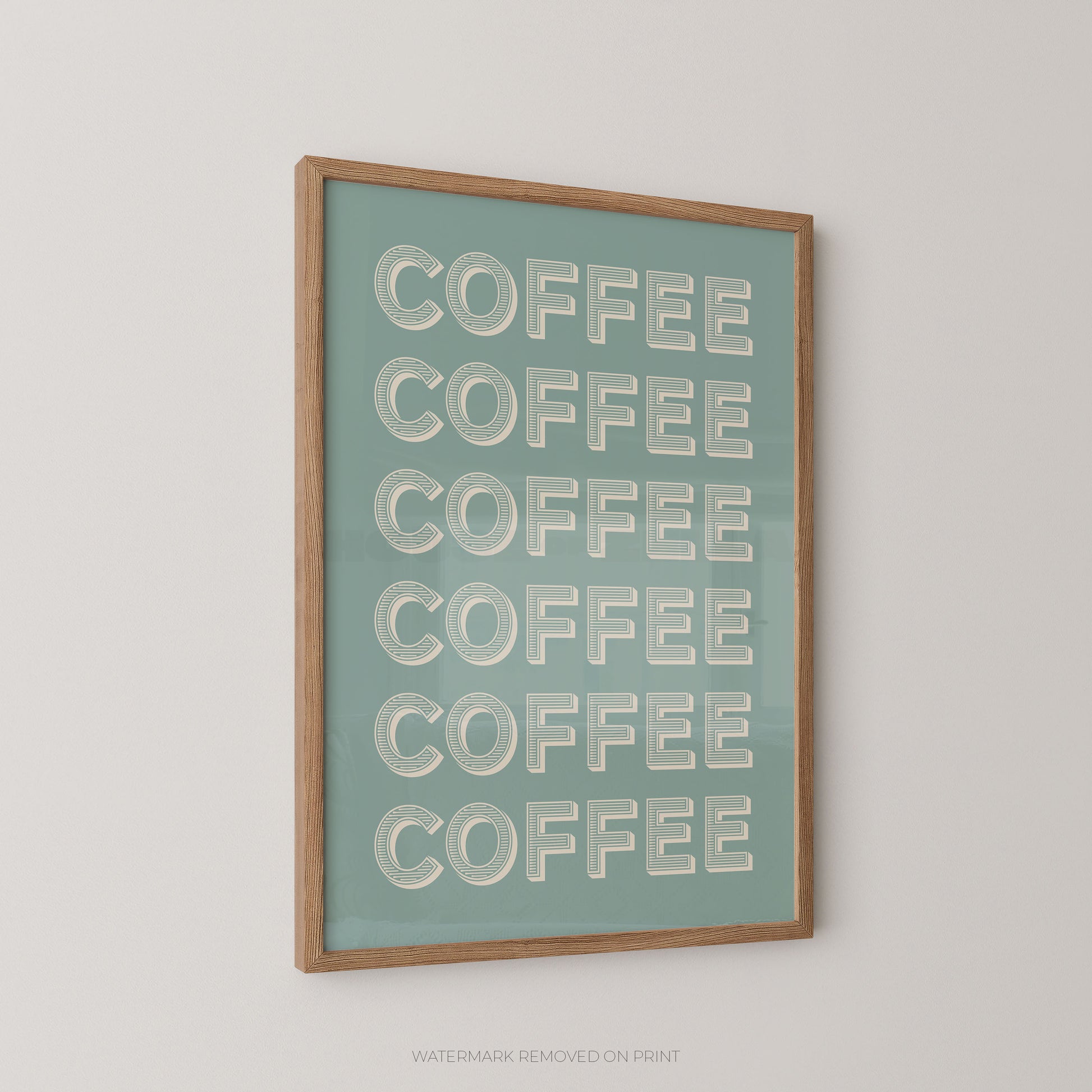 A framed wall art print featuring the word 'COFFEE' repeated six times in large white letters on a muted teal background, enclosed in a light natural wood frame and shown hanging on a plain light wall.