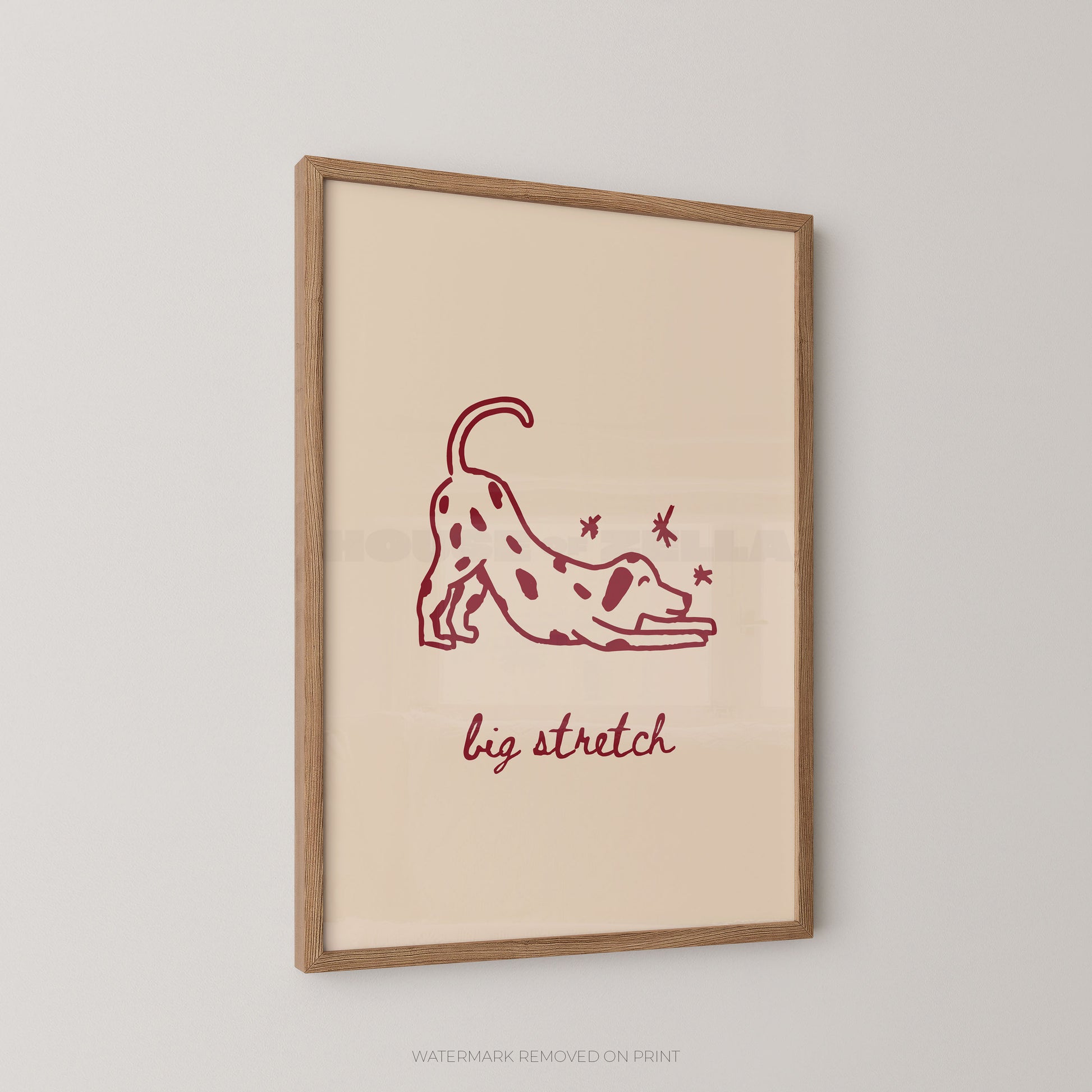 Framed artwork with a red illustration of a dog stretching and text 'big stretch' on a beige background.