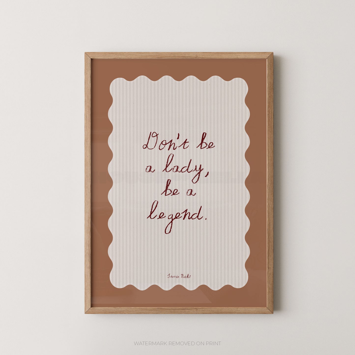 Framed print with motivational quote 'Don't be a lady, be a legend' on a white background
