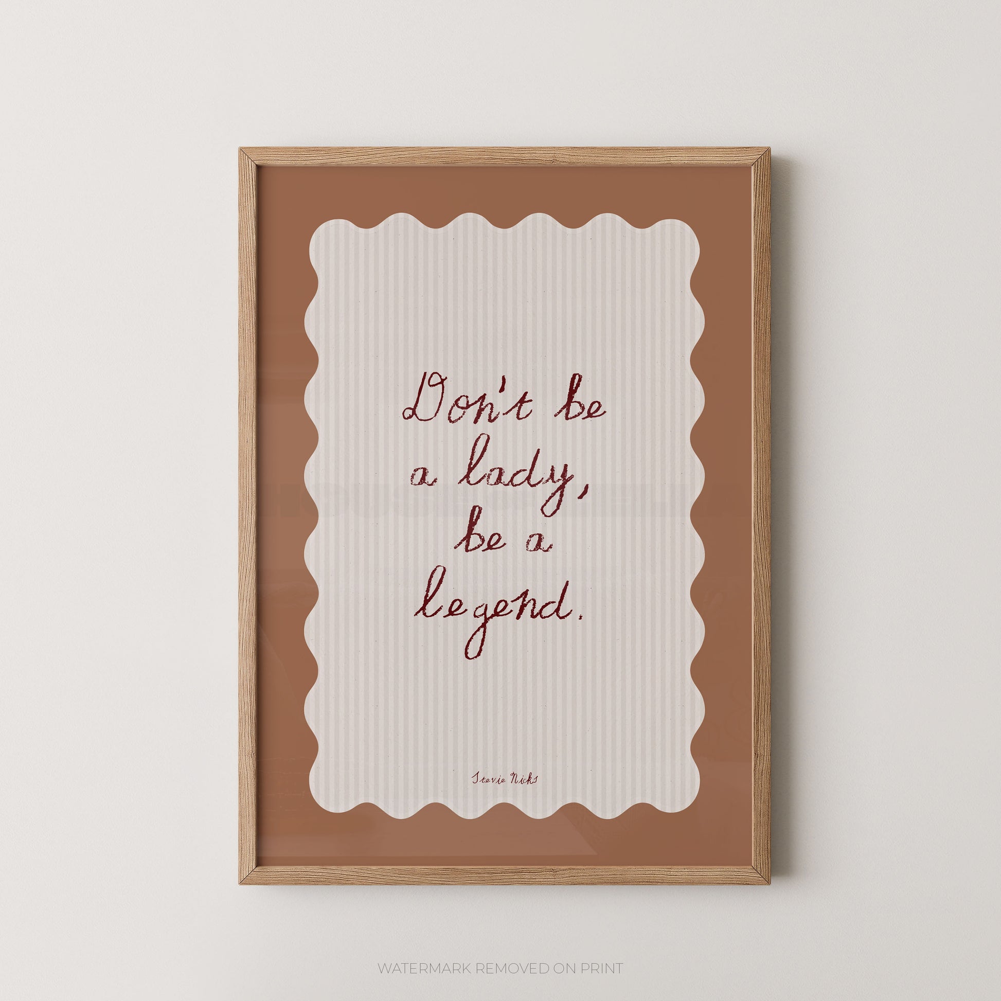 Framed print with motivational quote 'Don't be a lady, be a legend' on a white background