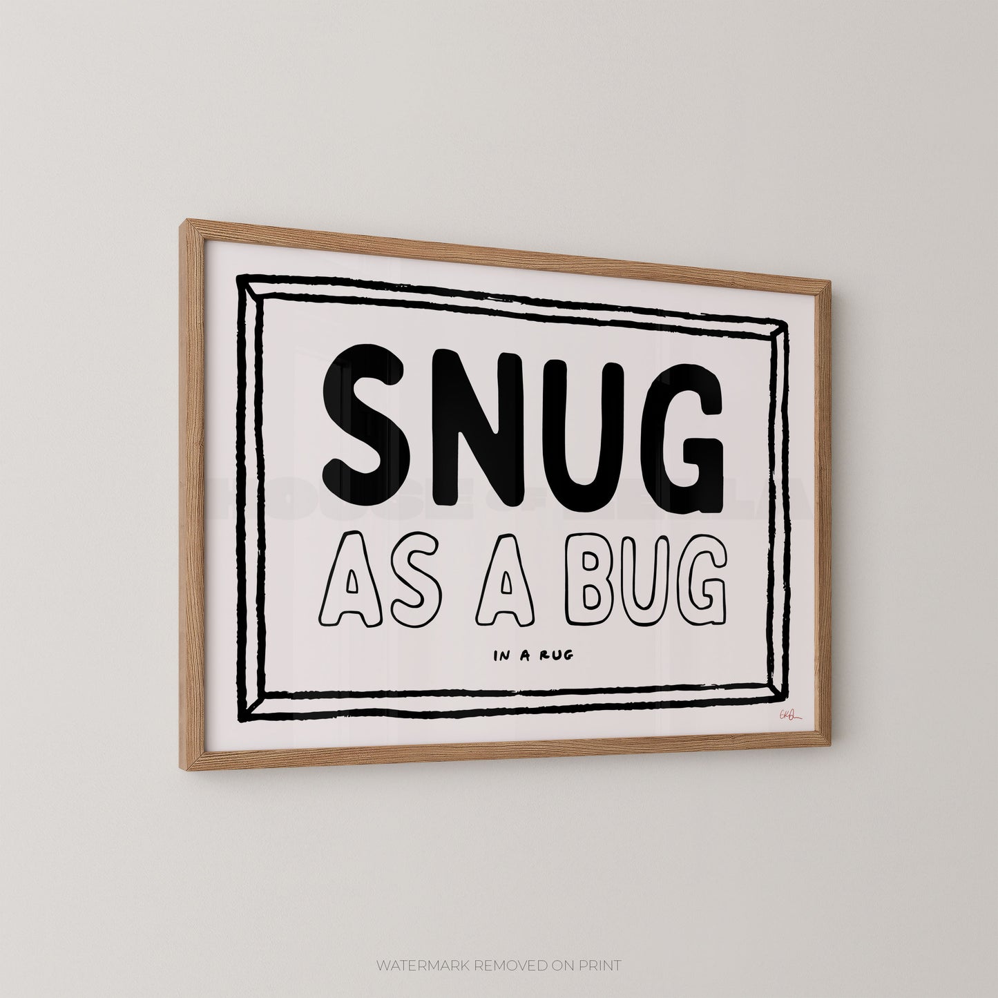 Framed print with 'SNUG AS A BUG' text on a plain wall