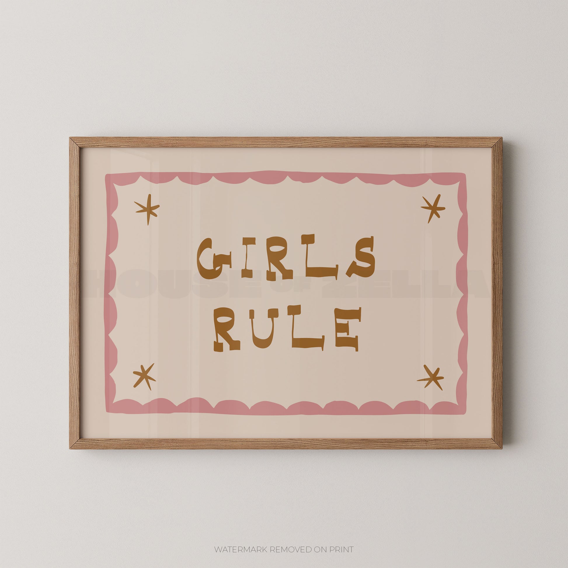 "Girls Rule children's wall art print with bold gold retro lettering on a cream background, pink scallop border with gold star details, displayed straight-on in an oak frame"

