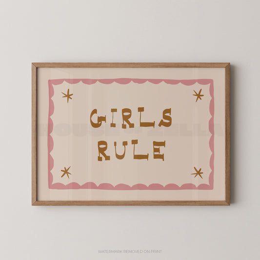 "Girls Rule children's wall art print with bold gold retro lettering on a cream background, pink scallop border with gold star details, displayed straight-on in an oak frame"

