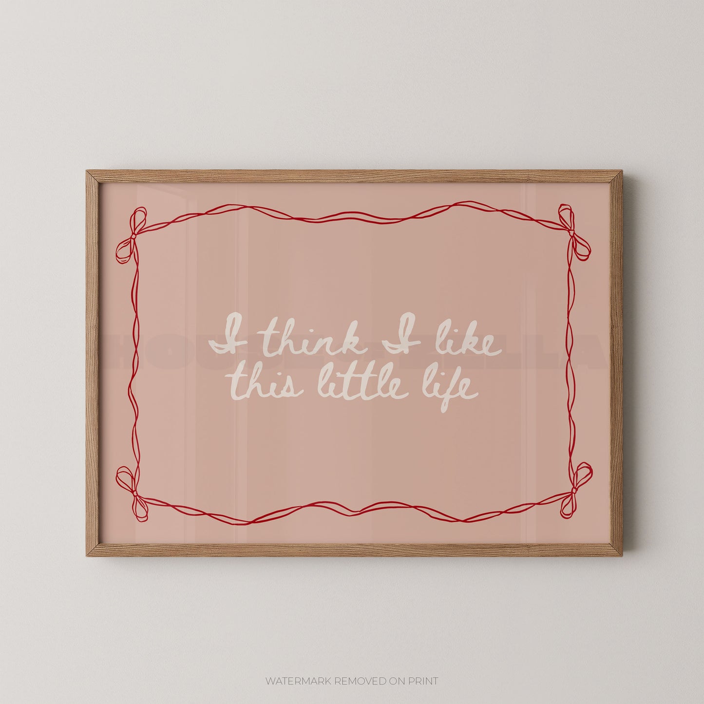 Framed print with 'I think I like this little life' text on a pink background
