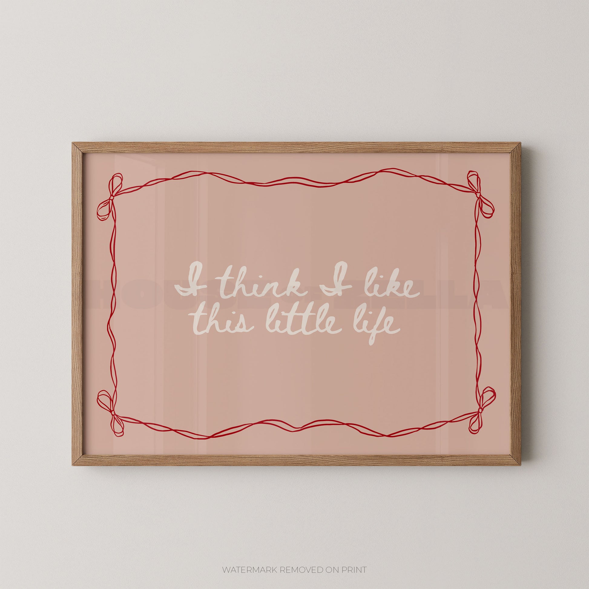 Framed print with 'I think I like this little life' text on a pink background