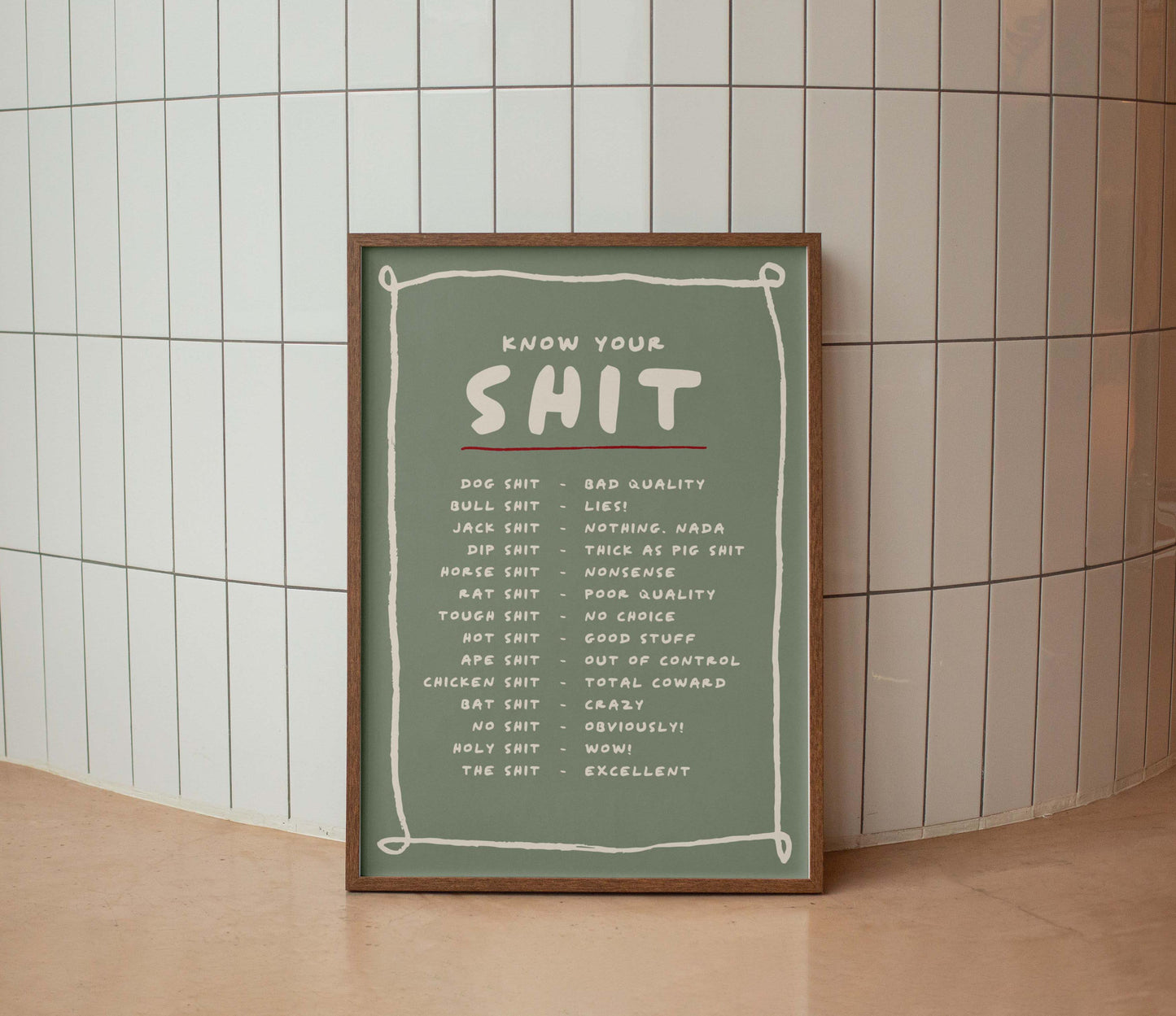 Framed poster with text on a tiled wall